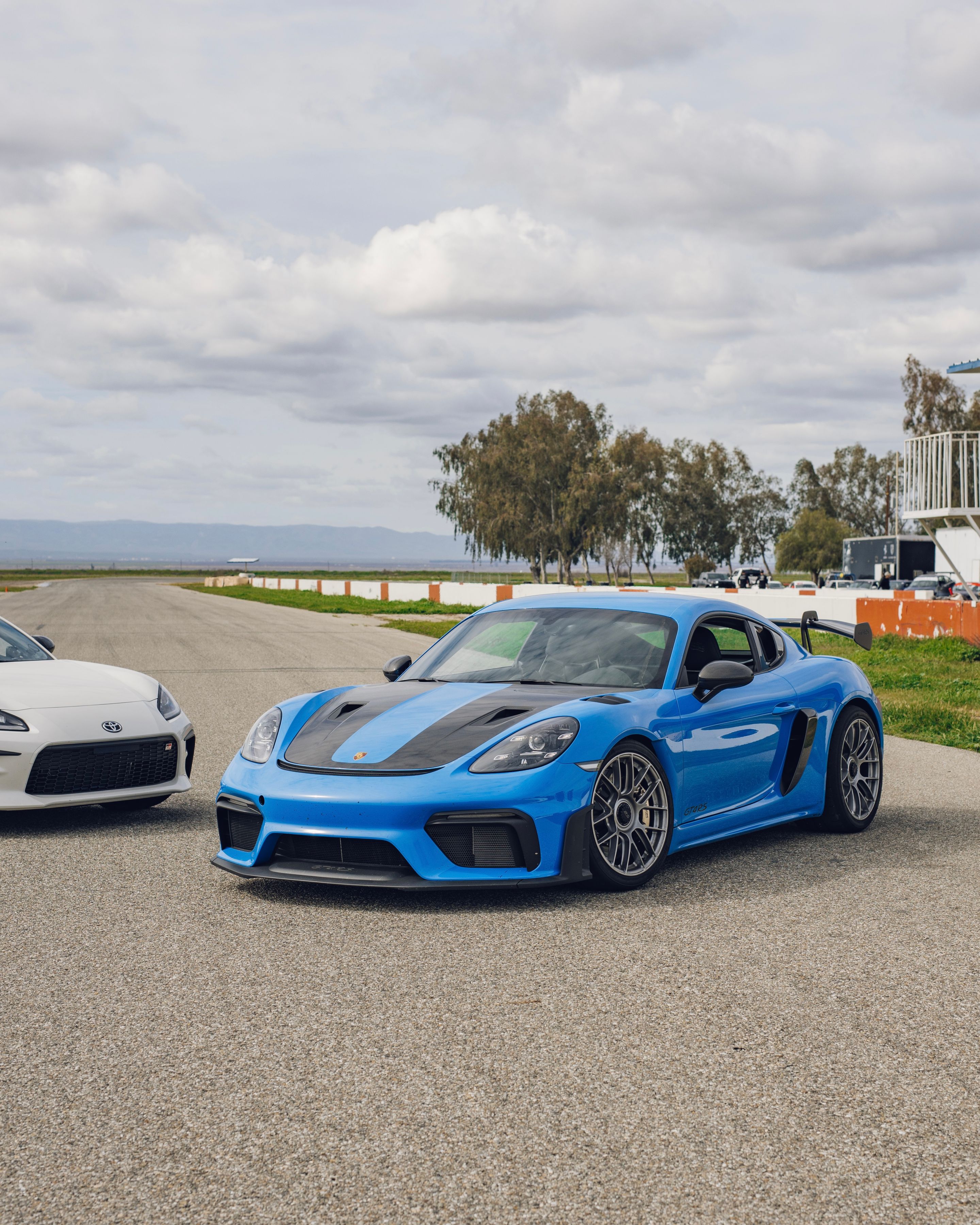 Blue Porsche 718 Cayman GT4 RS with 19" EC-7RS Apex wheels in Race Silver