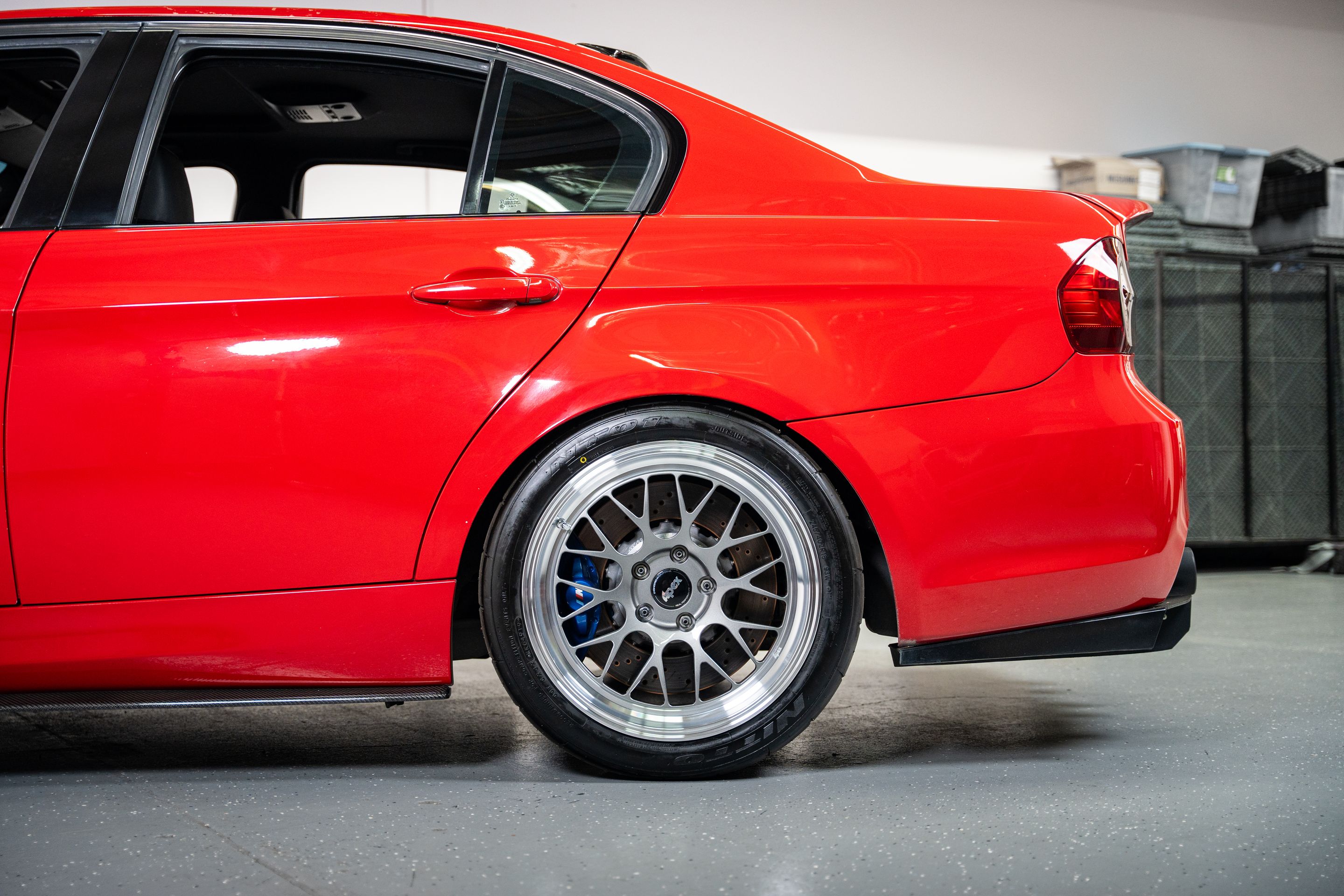 Red BMW E90 Sedan 3 Series with 18" ML-10RT Apex wheels in Machined Lip Anthracite