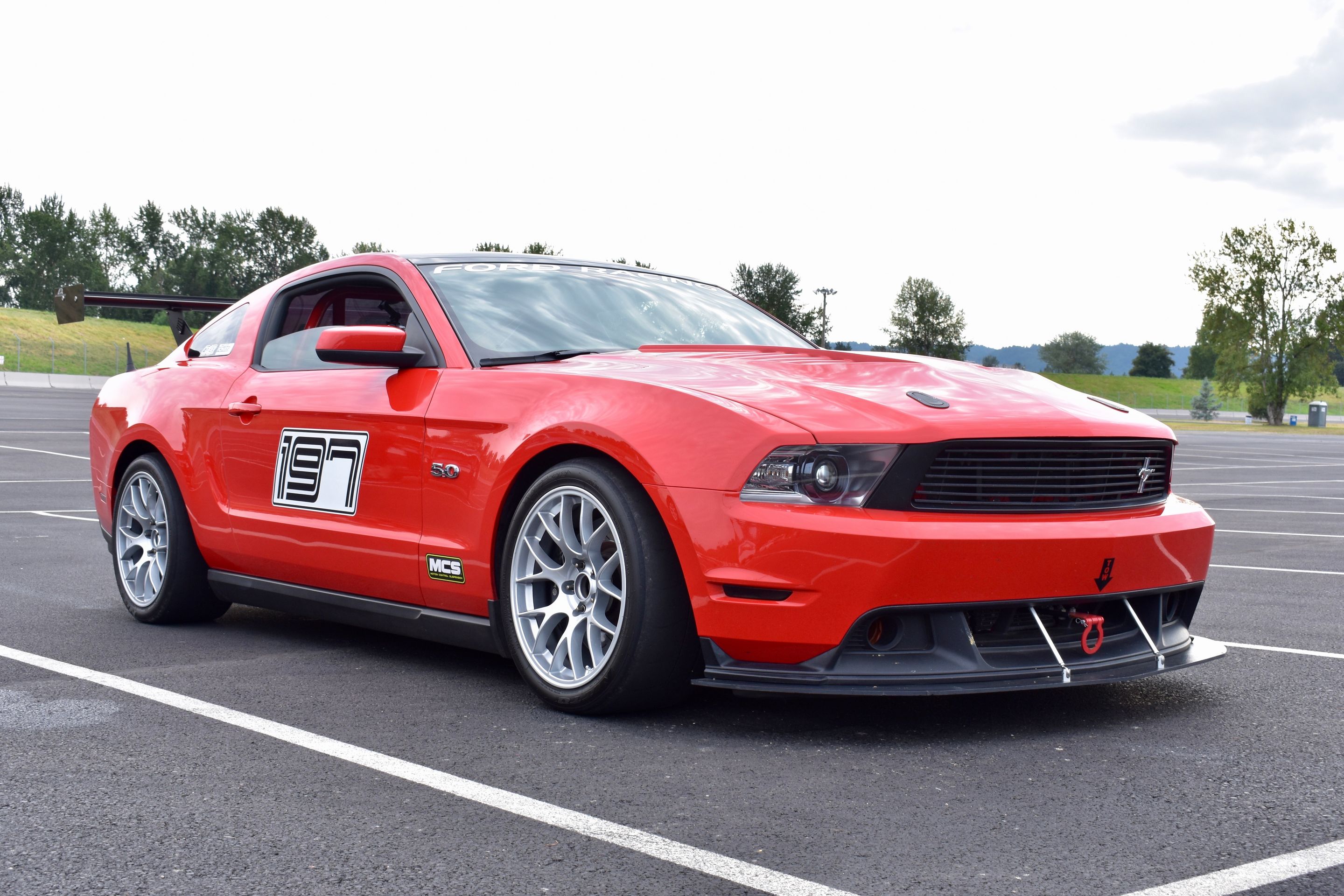 Red Ford S197 Mustang GT with 18" EC-7 Apex wheels in Race Silver