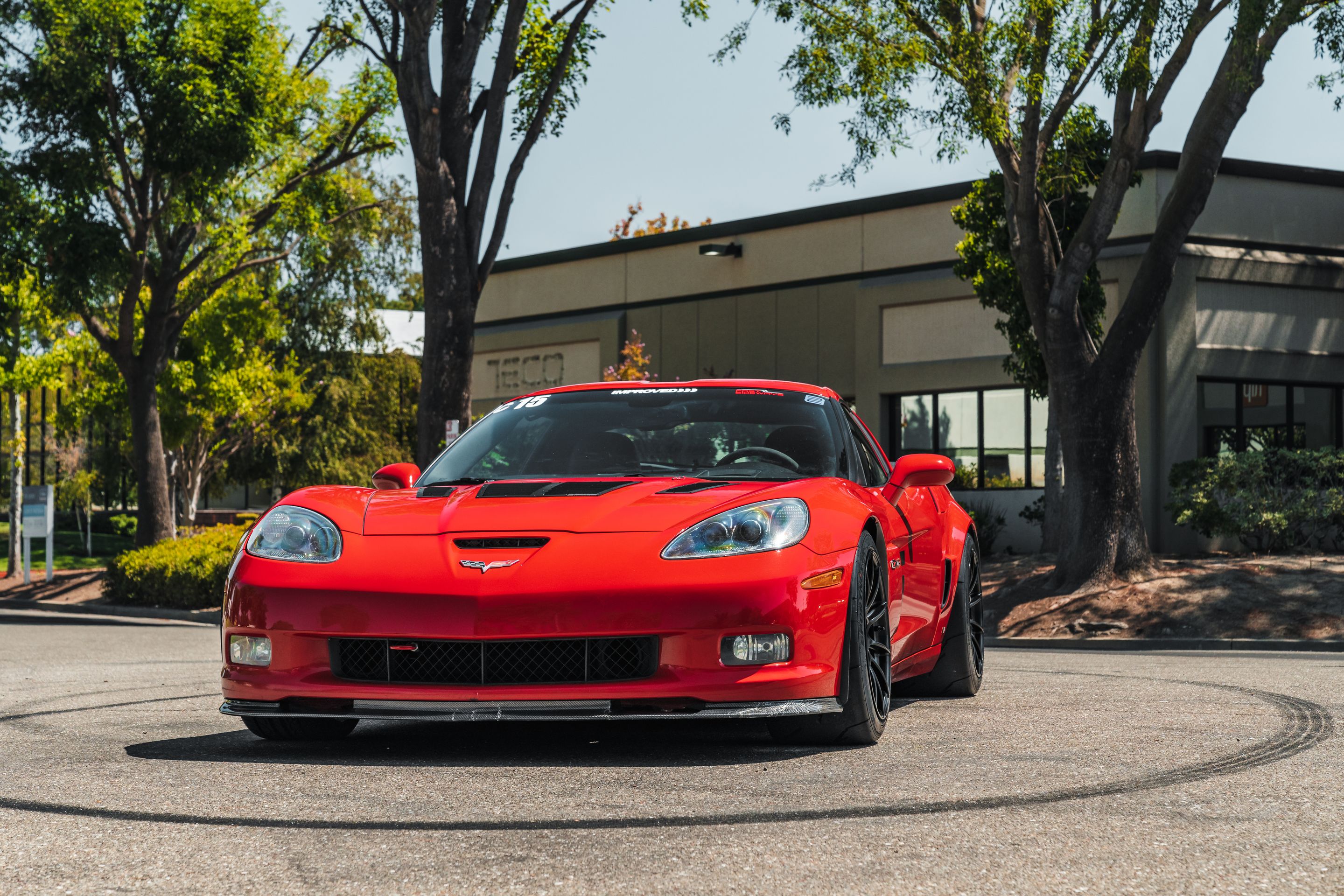 Red Chevrolet C6 Corvette Z06 with 18" SM-10RS Apex wheels in Satin Black