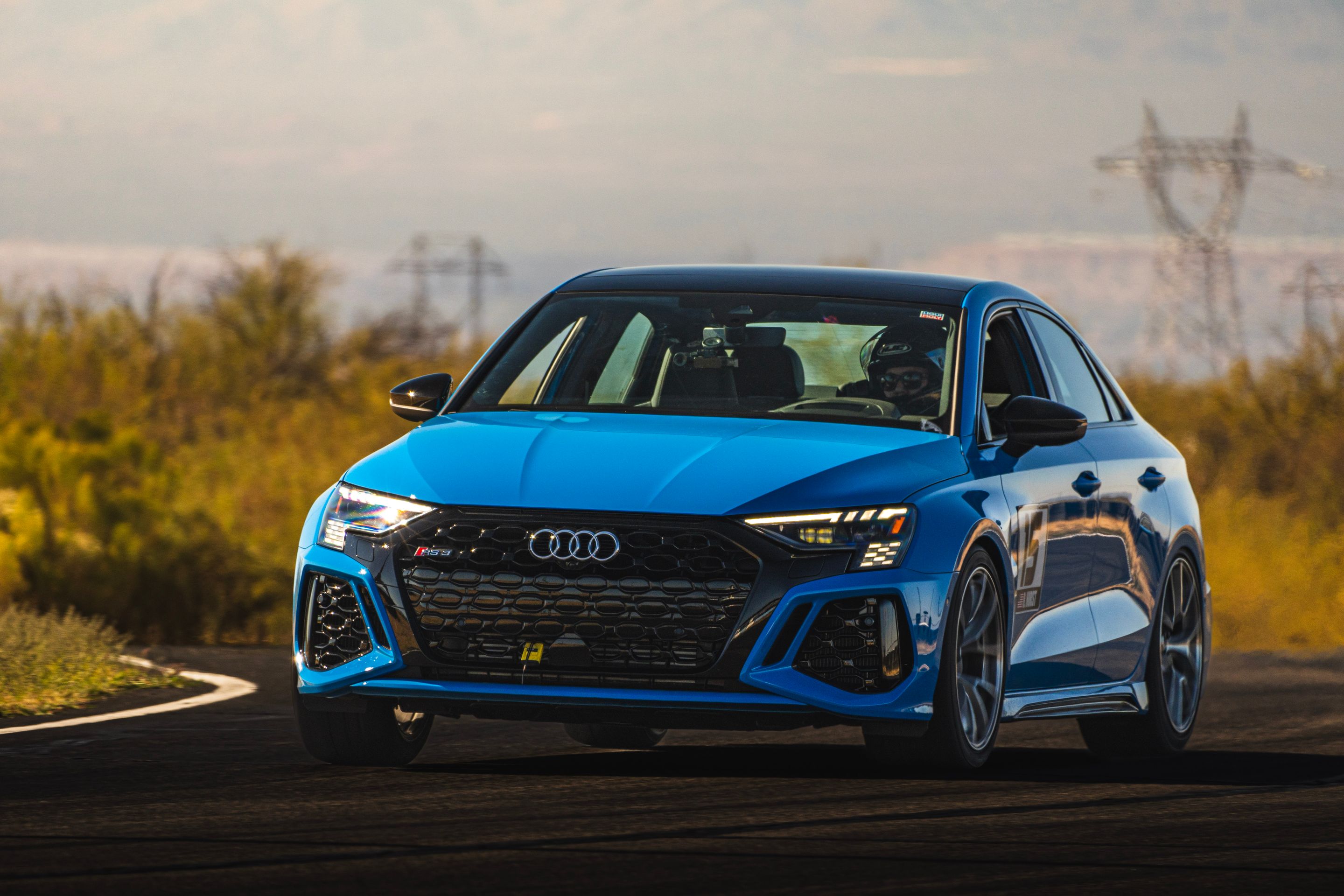 Blue Audi 8Y RS 3 with 18" VS-5RS Apex wheels in Brushed Clear