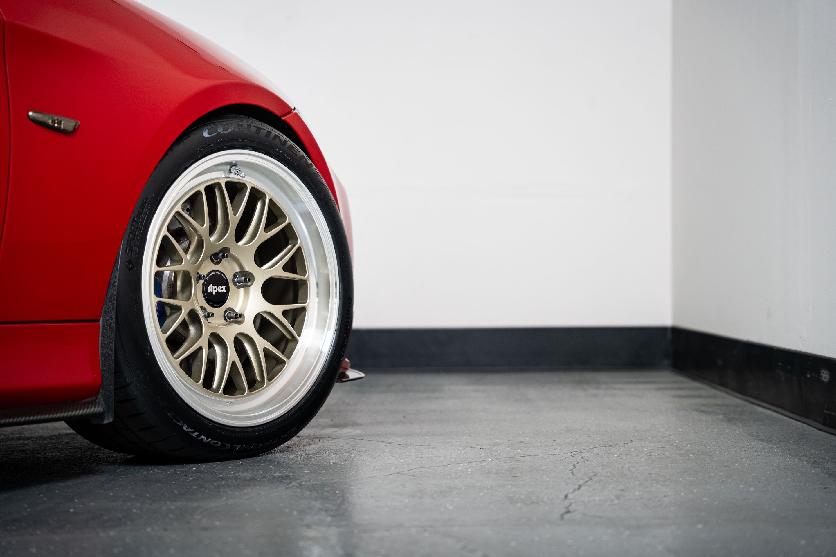 Red BMW E90 Sedan 3 Series with 18" ML-10RT Apex wheels in Machined Lip Gloss Motorsport Gold