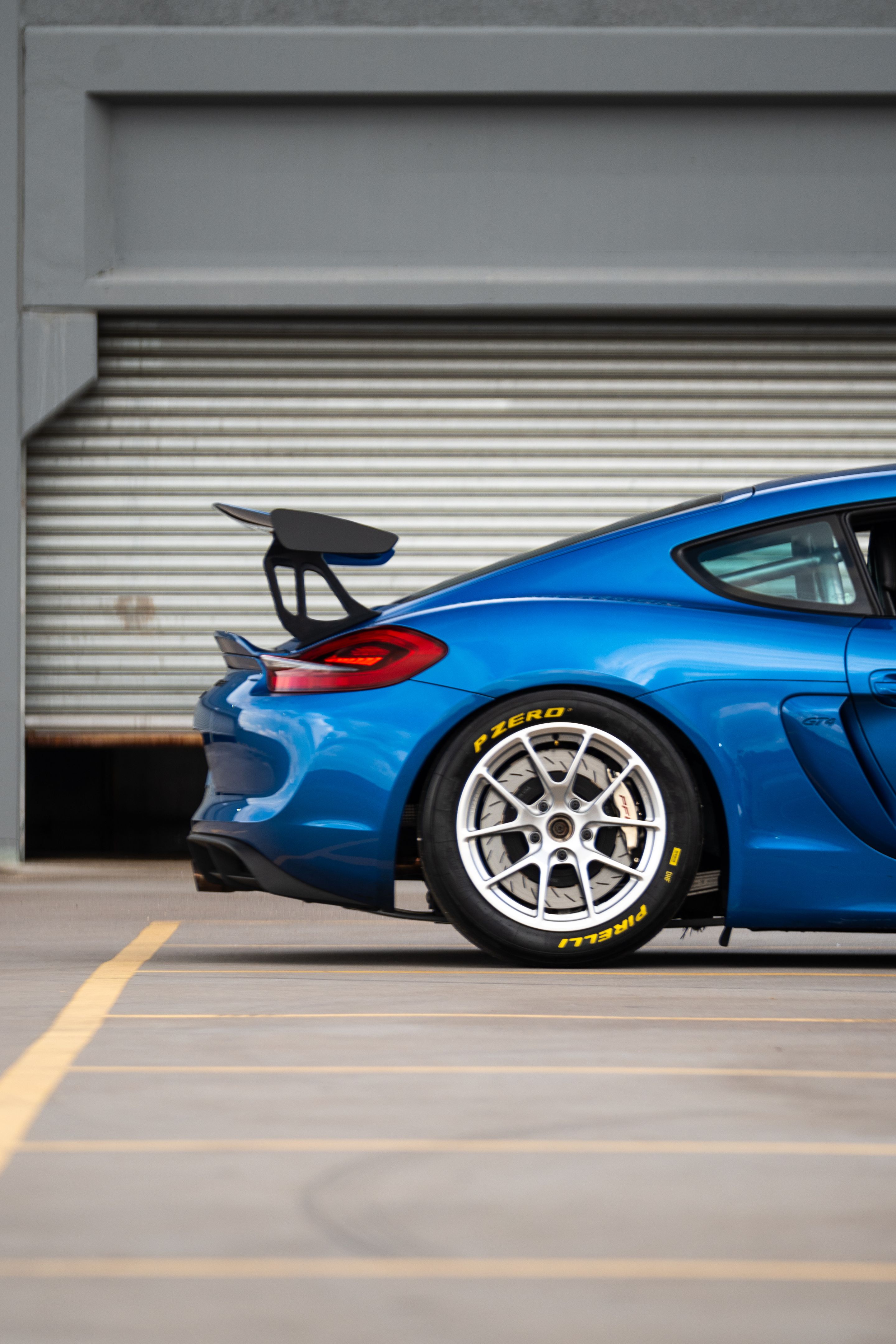 Blue Porsche 981 Cayman GT4 with 18" VS-5RE Apex wheels in Race Silver