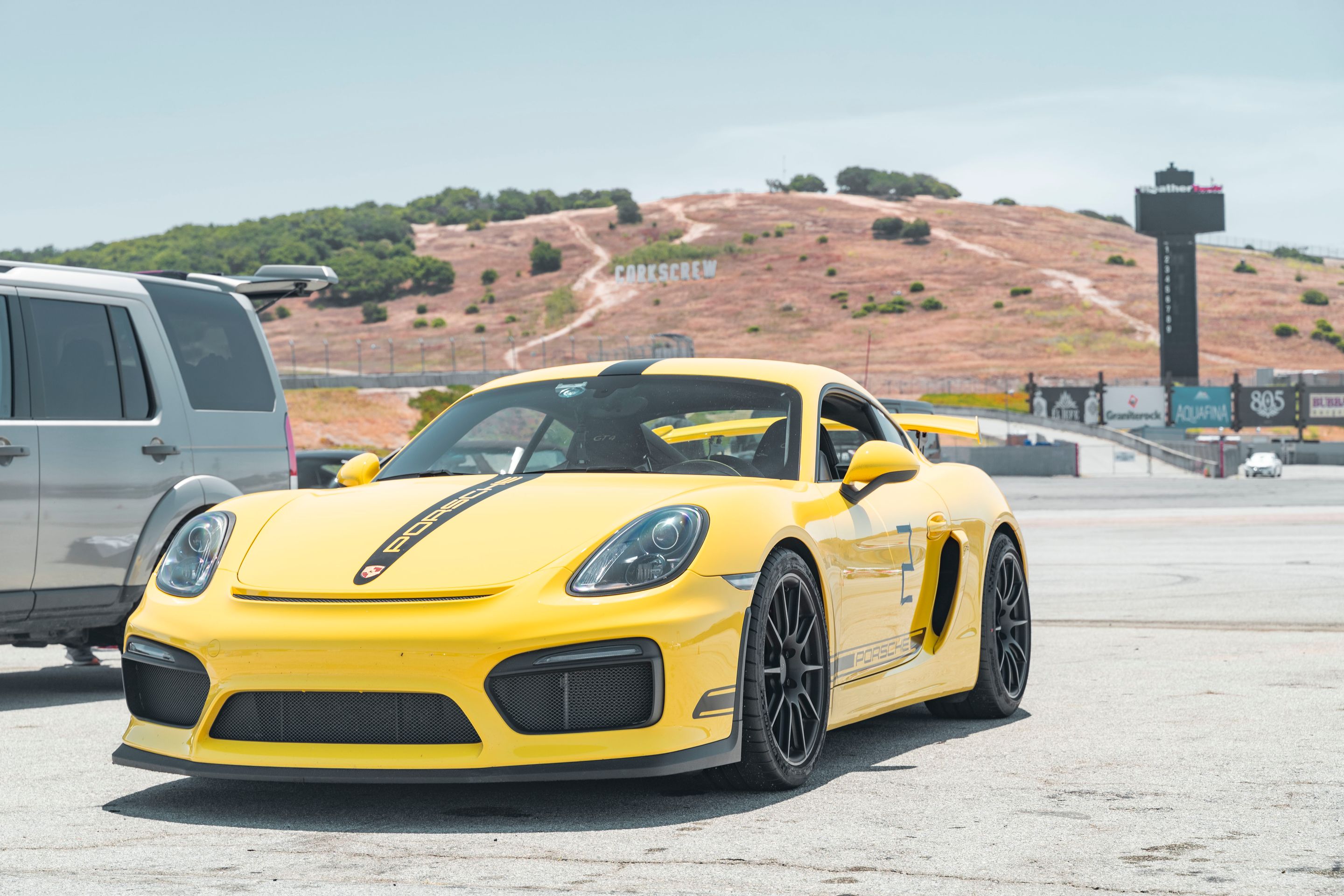 Yellow Porsche 981 Cayman GT4 with 19" SM-10 Apex wheels in Satin Black