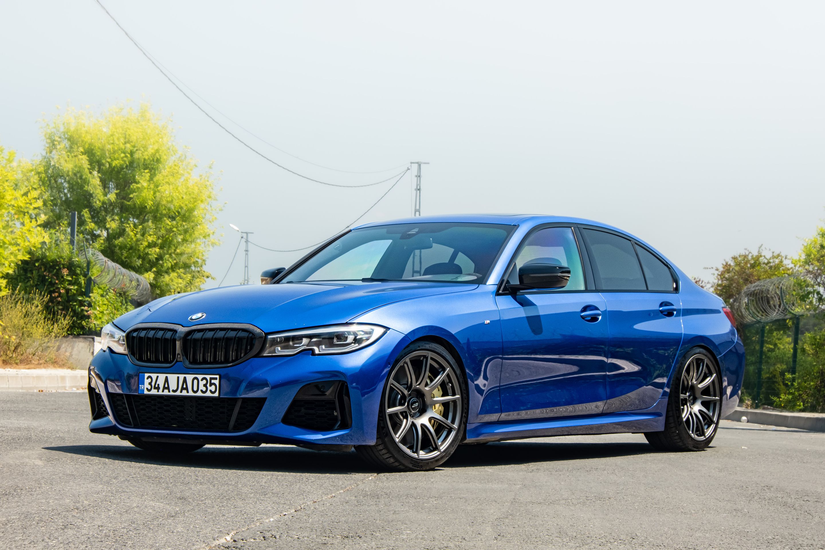 Blue BMW G20 Sedan 3 Series with 19" SM-10 Apex wheels in Anthracite