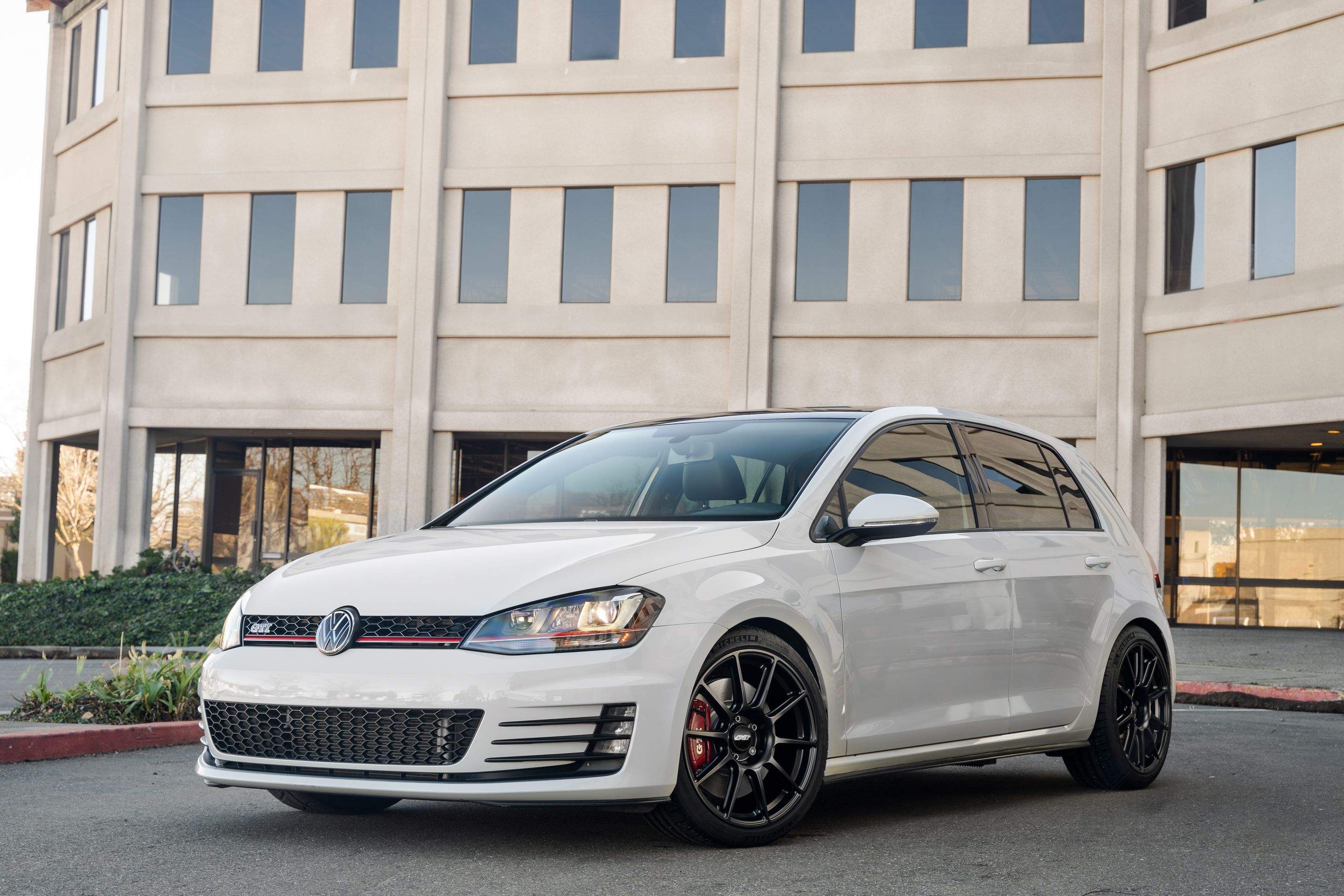 White VW MK7 GTI with 18" SM-10 Apex wheels in Satin Black