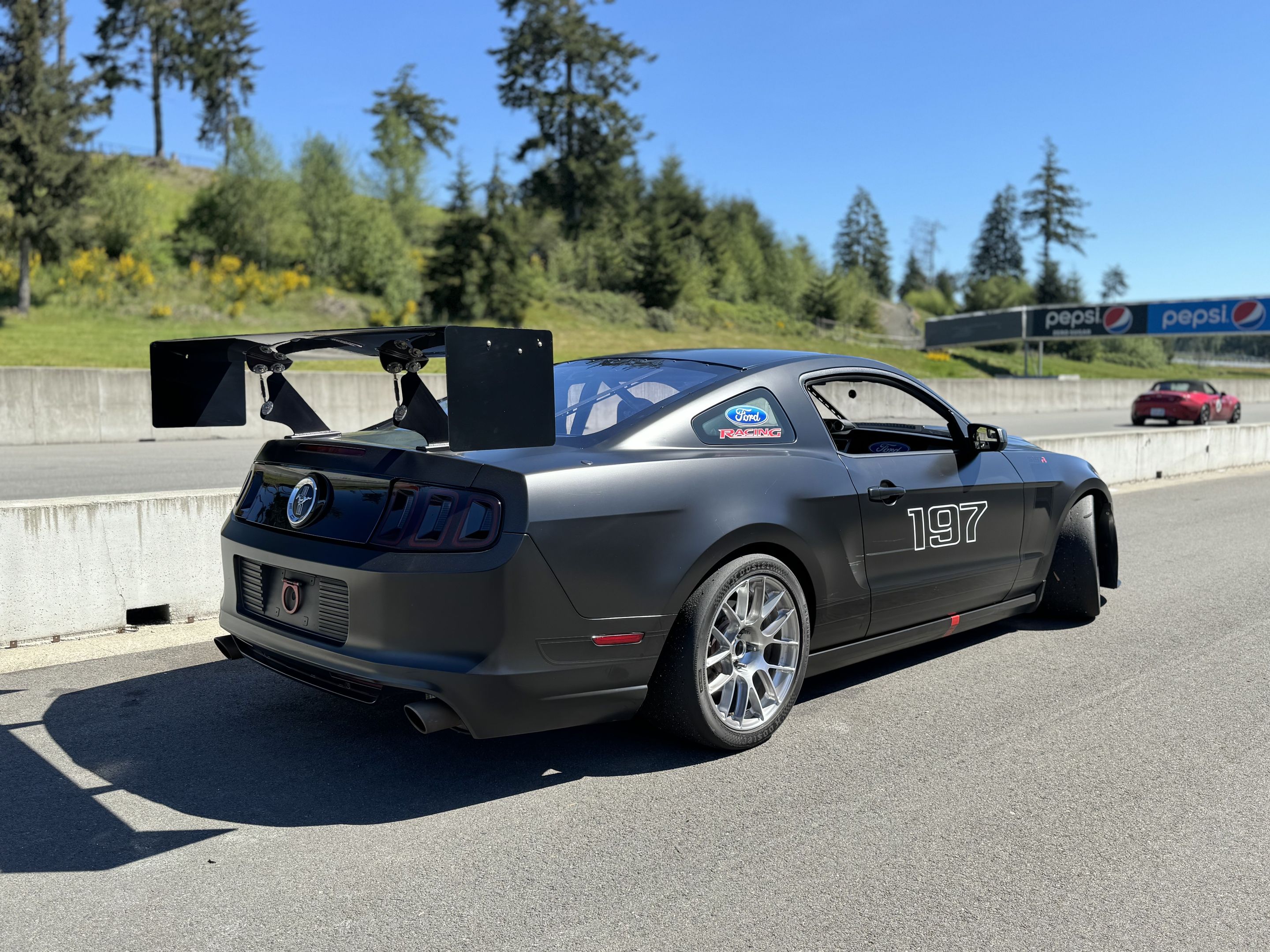 Black Ford S197 Mustang GT with 18" EC-7RS Apex wheels in Brushed Clear