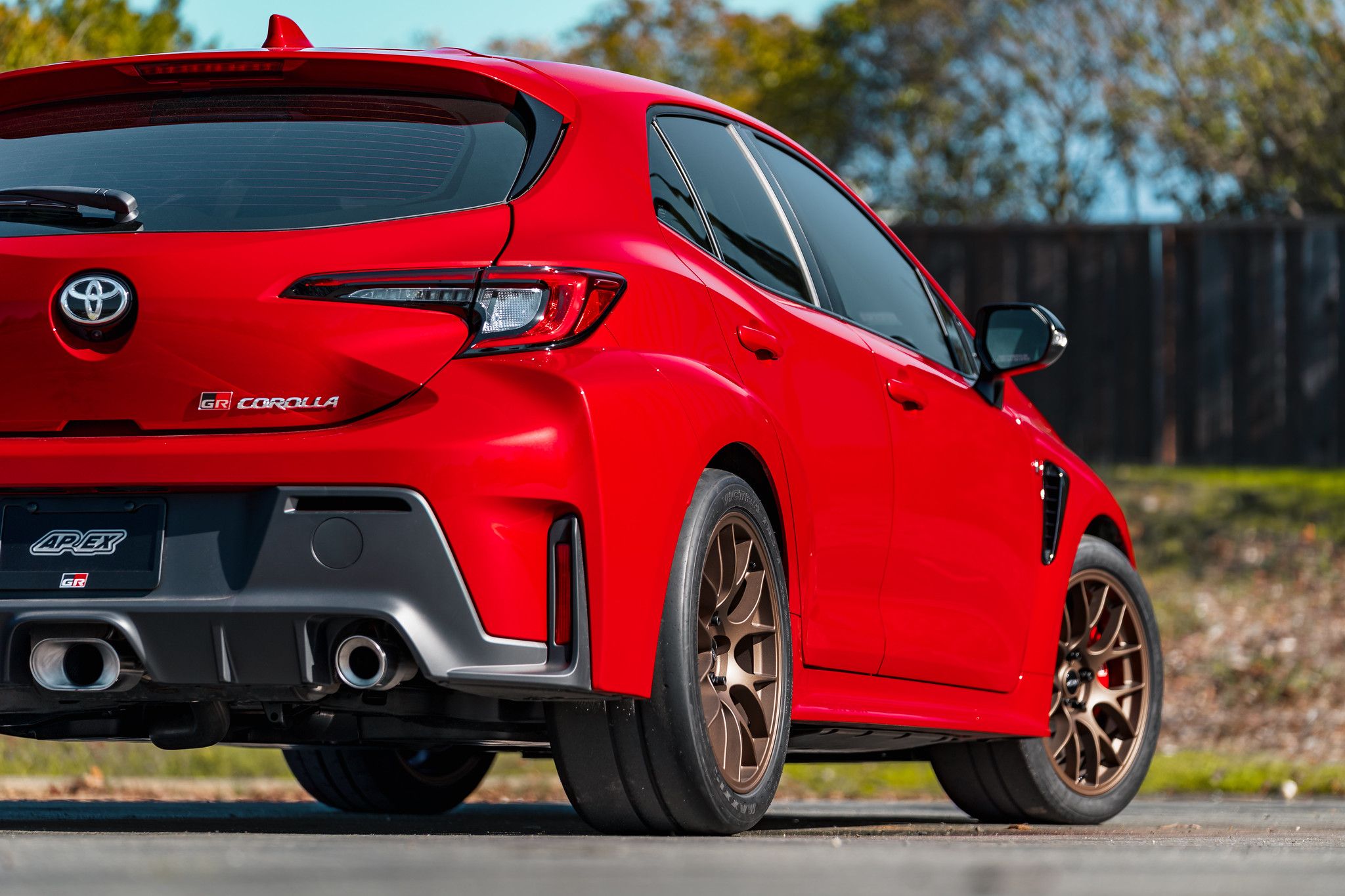 Red Toyota GR Corolla with 18" EC-7 Apex wheels in Satin Bronze