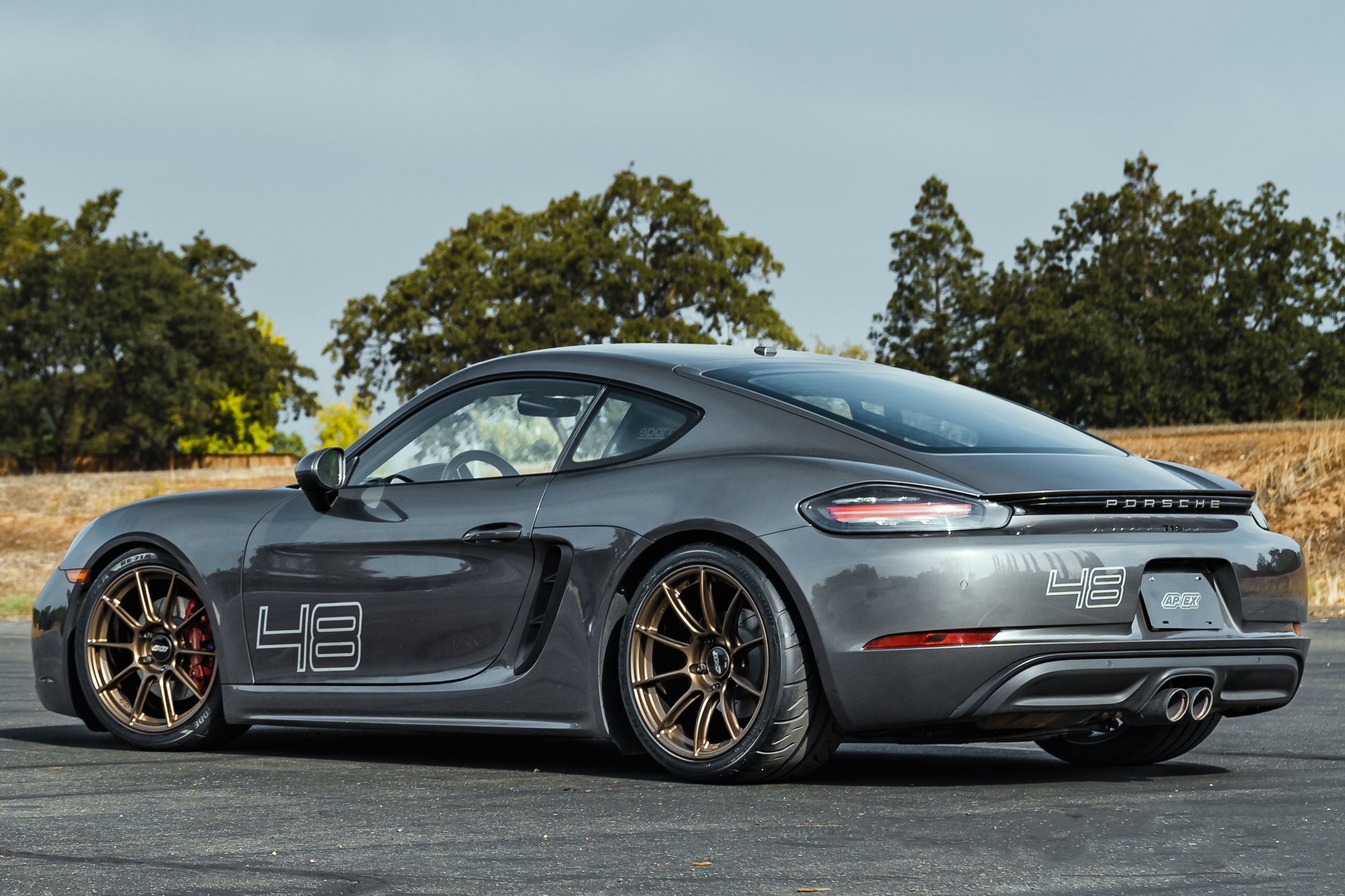 Grey Porsche 718 Cayman S with 19" SM-10RS Apex wheels in Satin Bronze