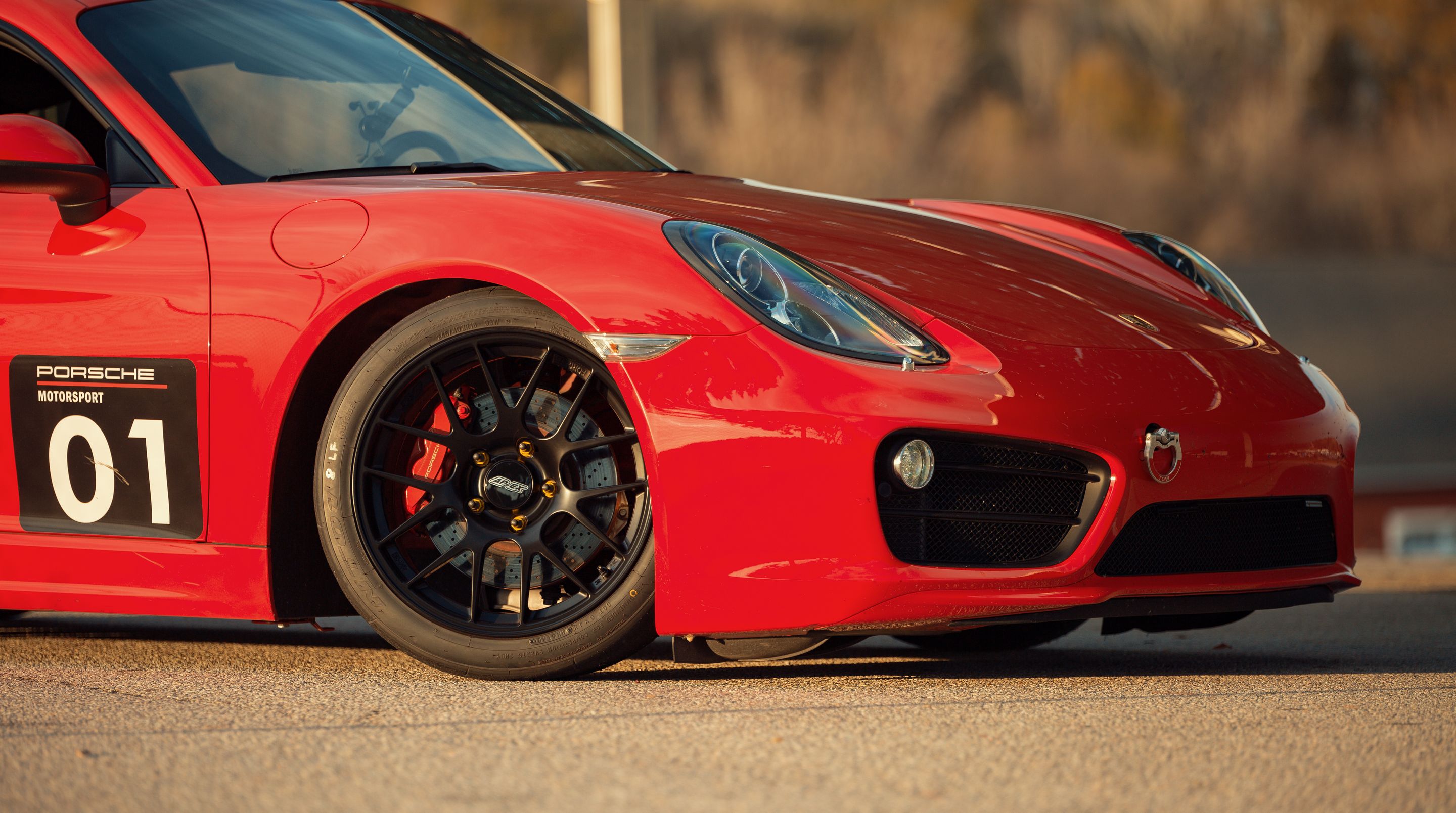 Red Porsche 981 Cayman S with 18" EC-7R Apex wheels in Satin Black