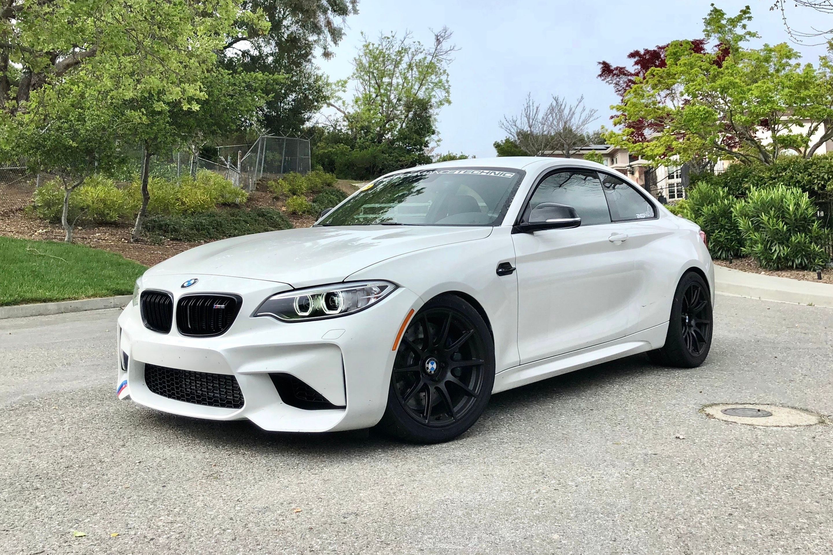 White BMW F87 M2 with 18" SM-10 Apex wheels in Satin Black