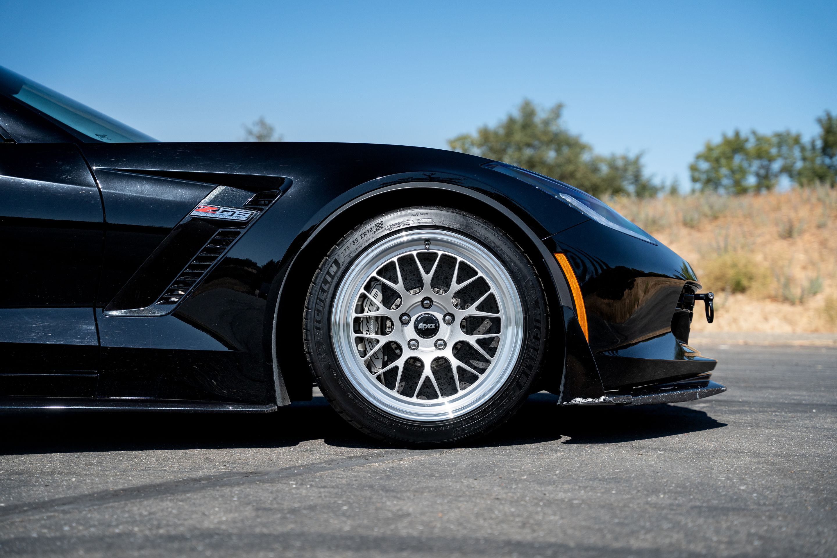 Black Chevrolet C7 Corvette Z06 with 18"/19" ML-10RT Apex wheels in Machined Lip Race Silver