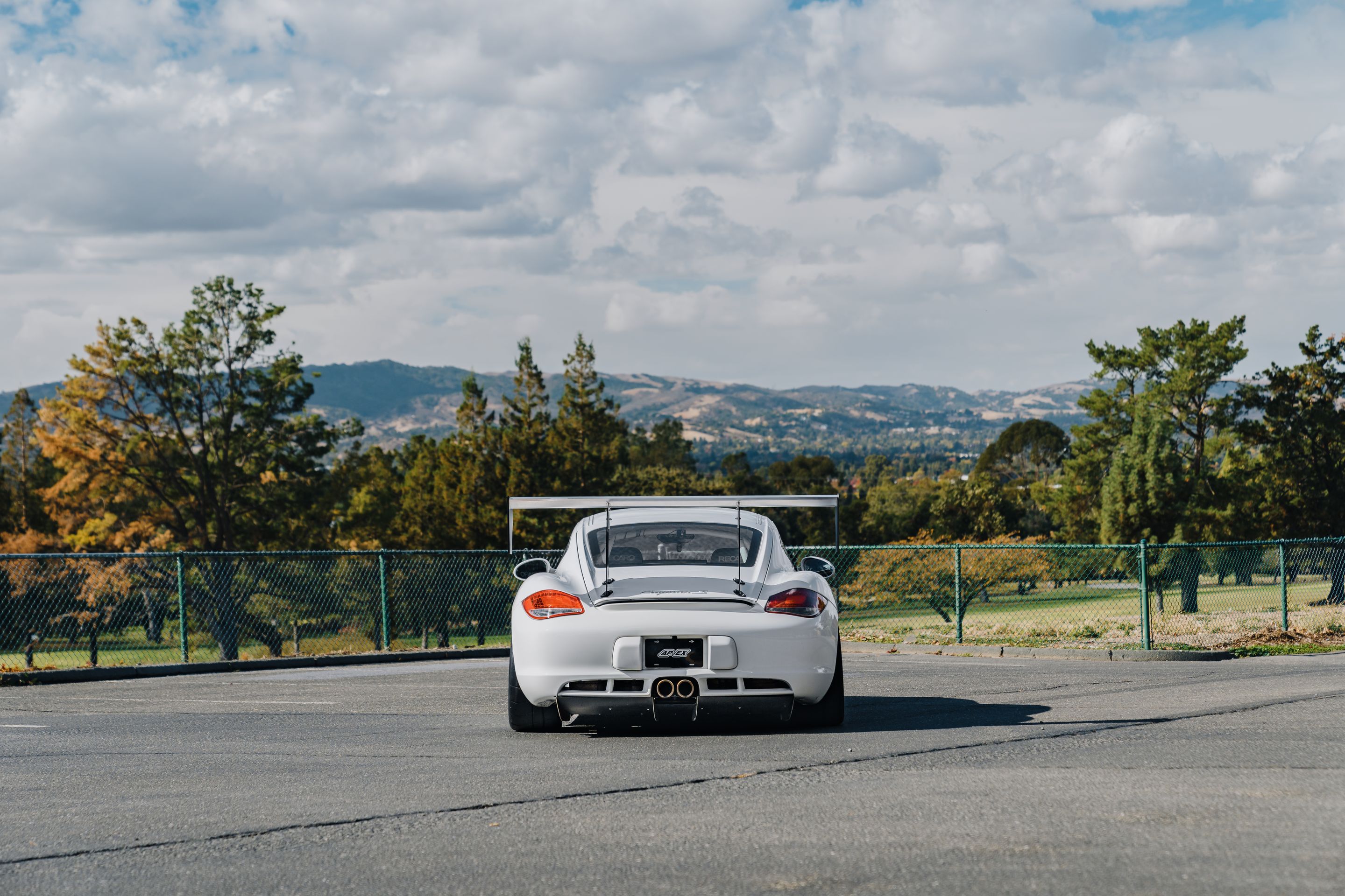 White Porsche 987 Cayman S with 18" SM-10RS Apex wheels in Satin Black