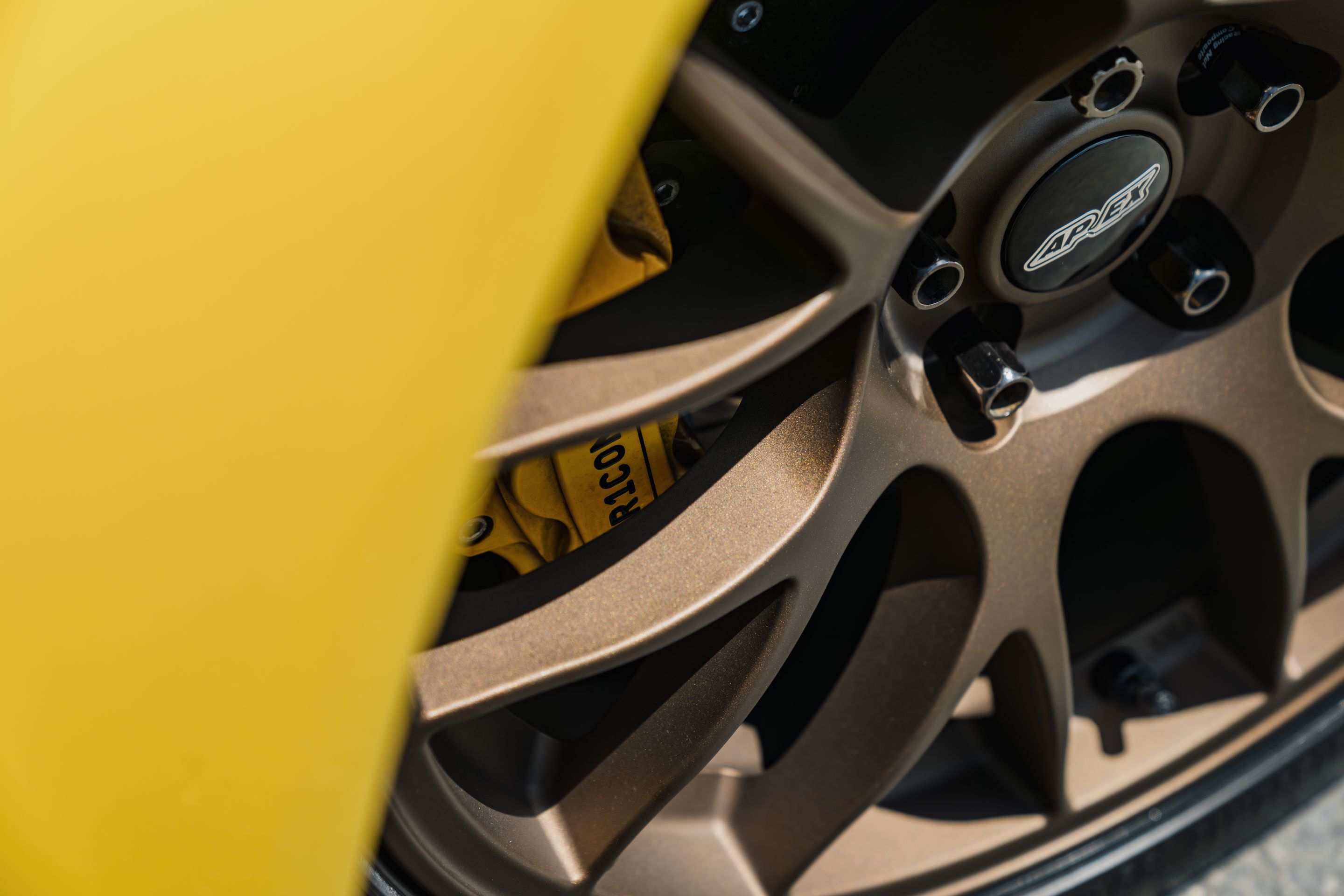 Yellow Mazda RX-8 with 18" EC-7 Apex wheels in Satin Bronze