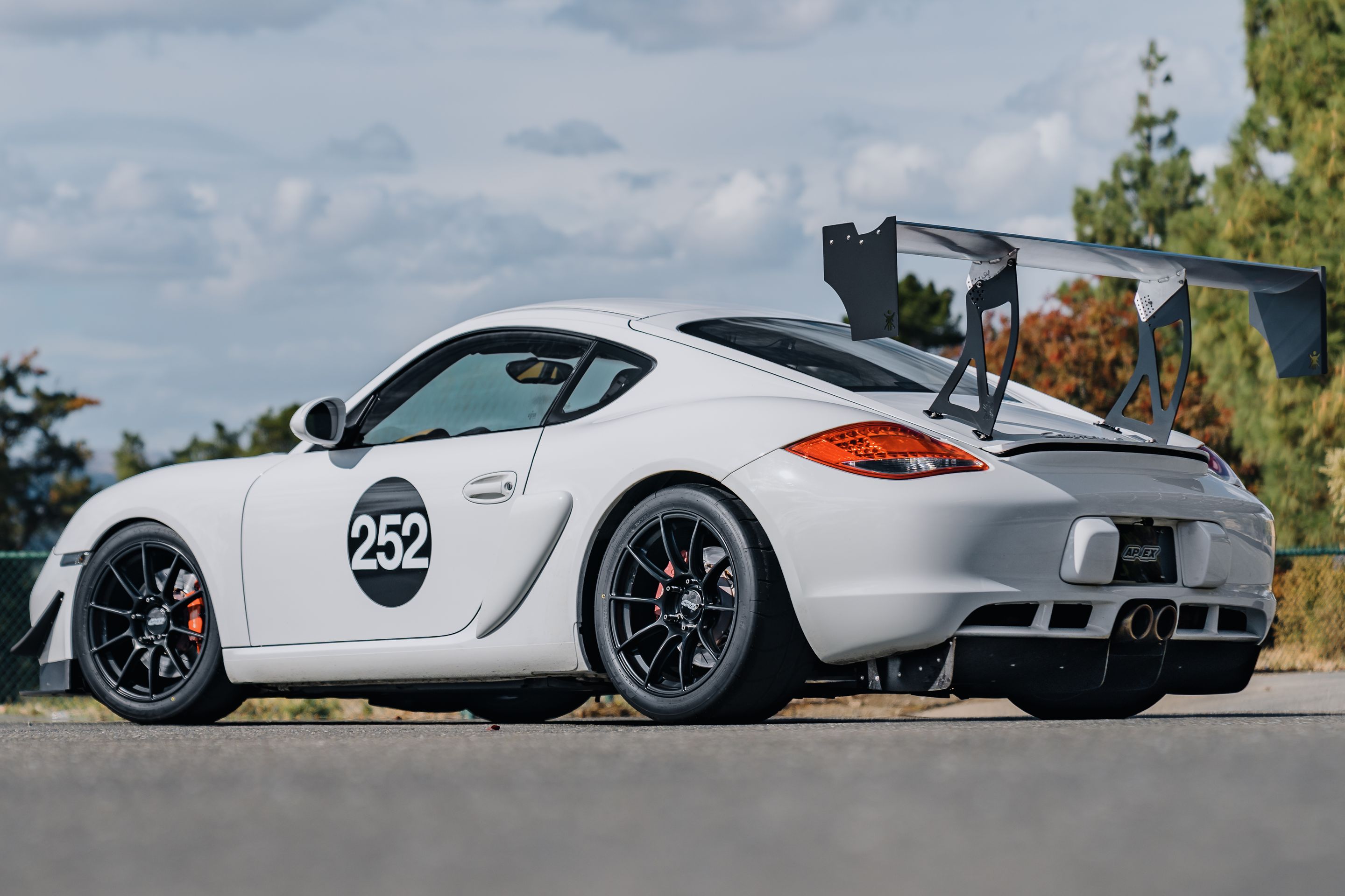 White Porsche 987 Cayman S with 18" SM-10RS Apex wheels in Satin Black