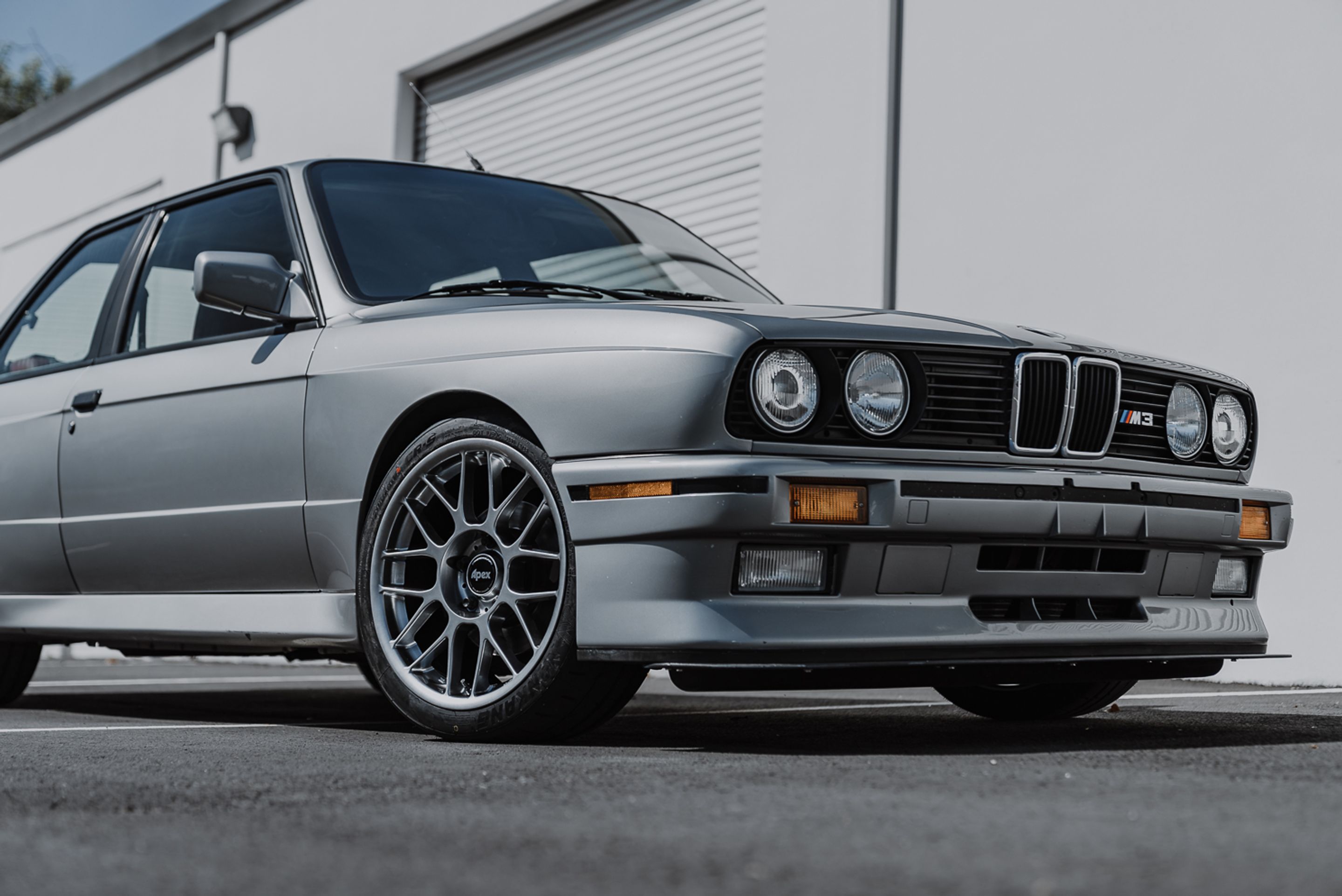 Silver BMW E30 M3 with 17" ARC-8 Apex wheels in Hyper Black