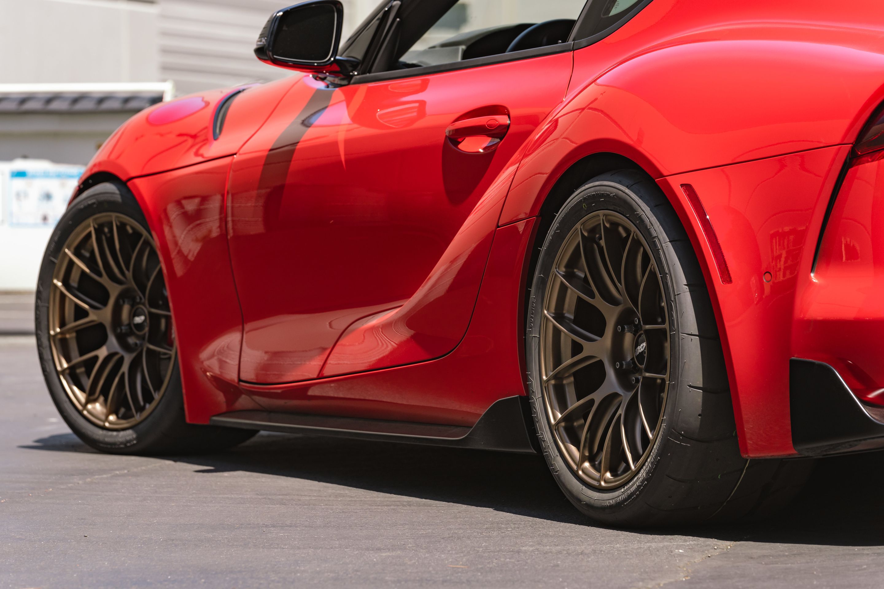 Red Toyota GR Supra with 18" EC-7RS Apex wheels in Satin Bronze