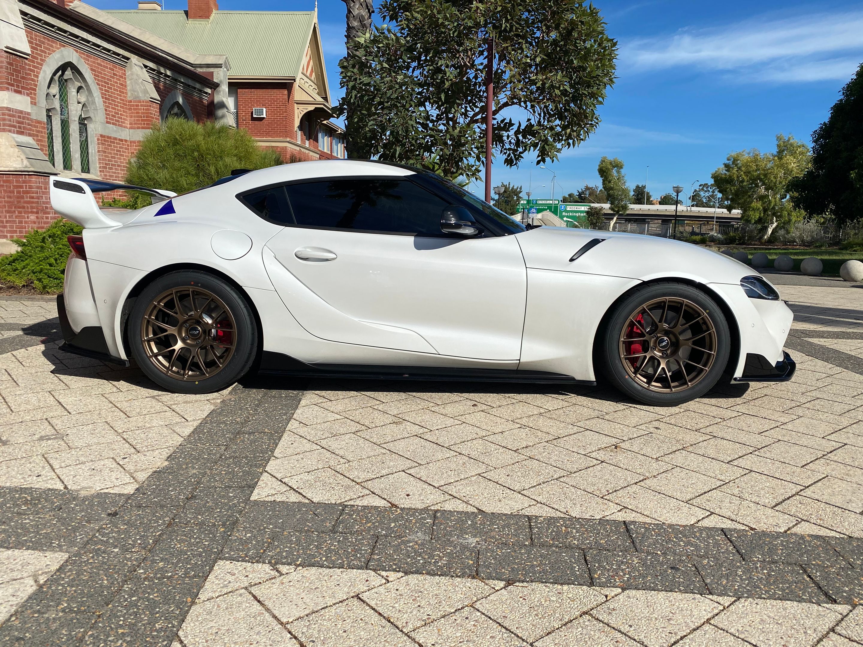 White Toyota GR Supra with 18" EC-7RS Apex wheels in Satin Bronze