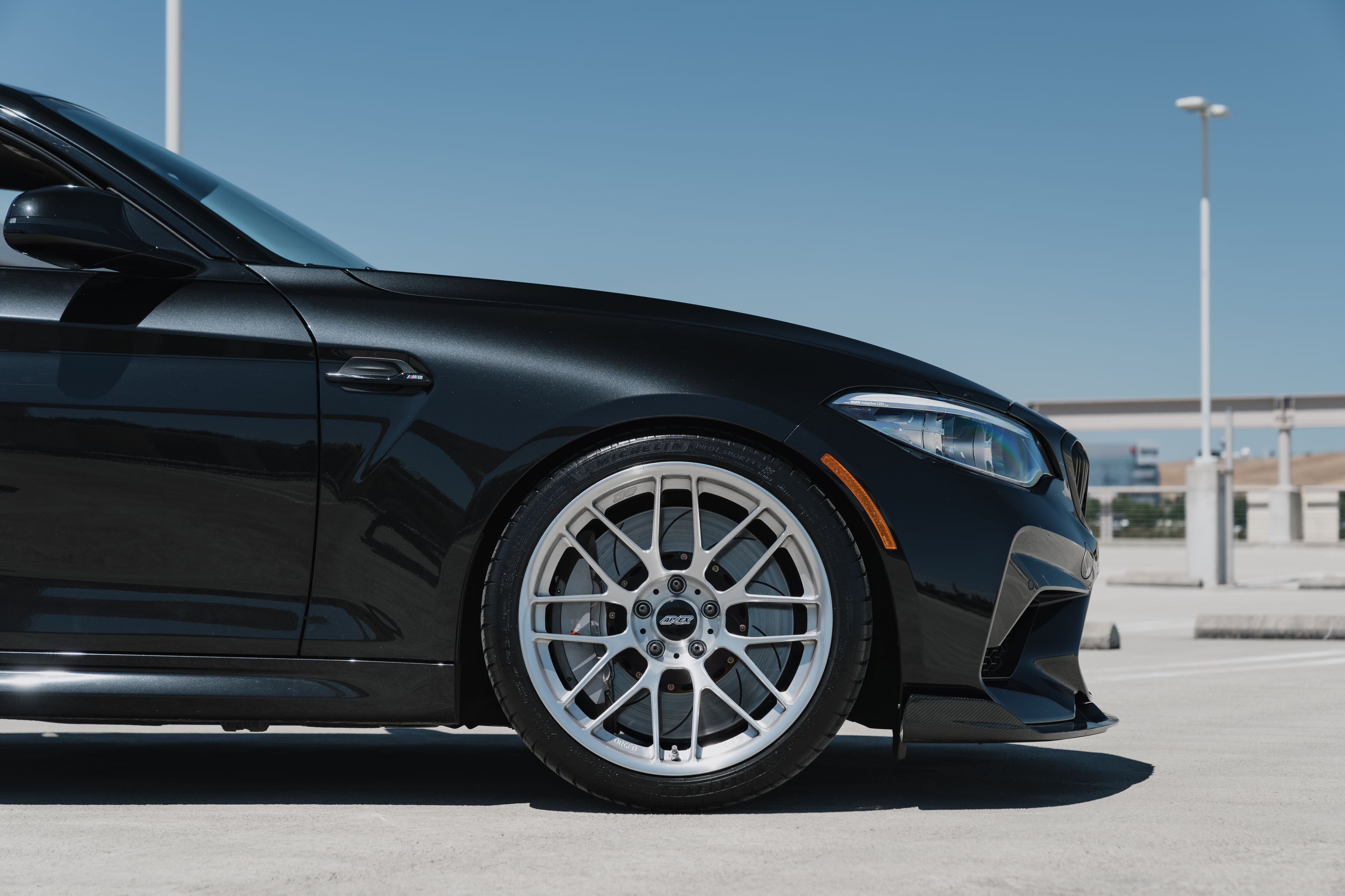 Black BMW F87 M2 with 19" ARC-8RT Apex wheels in Brushed Clear