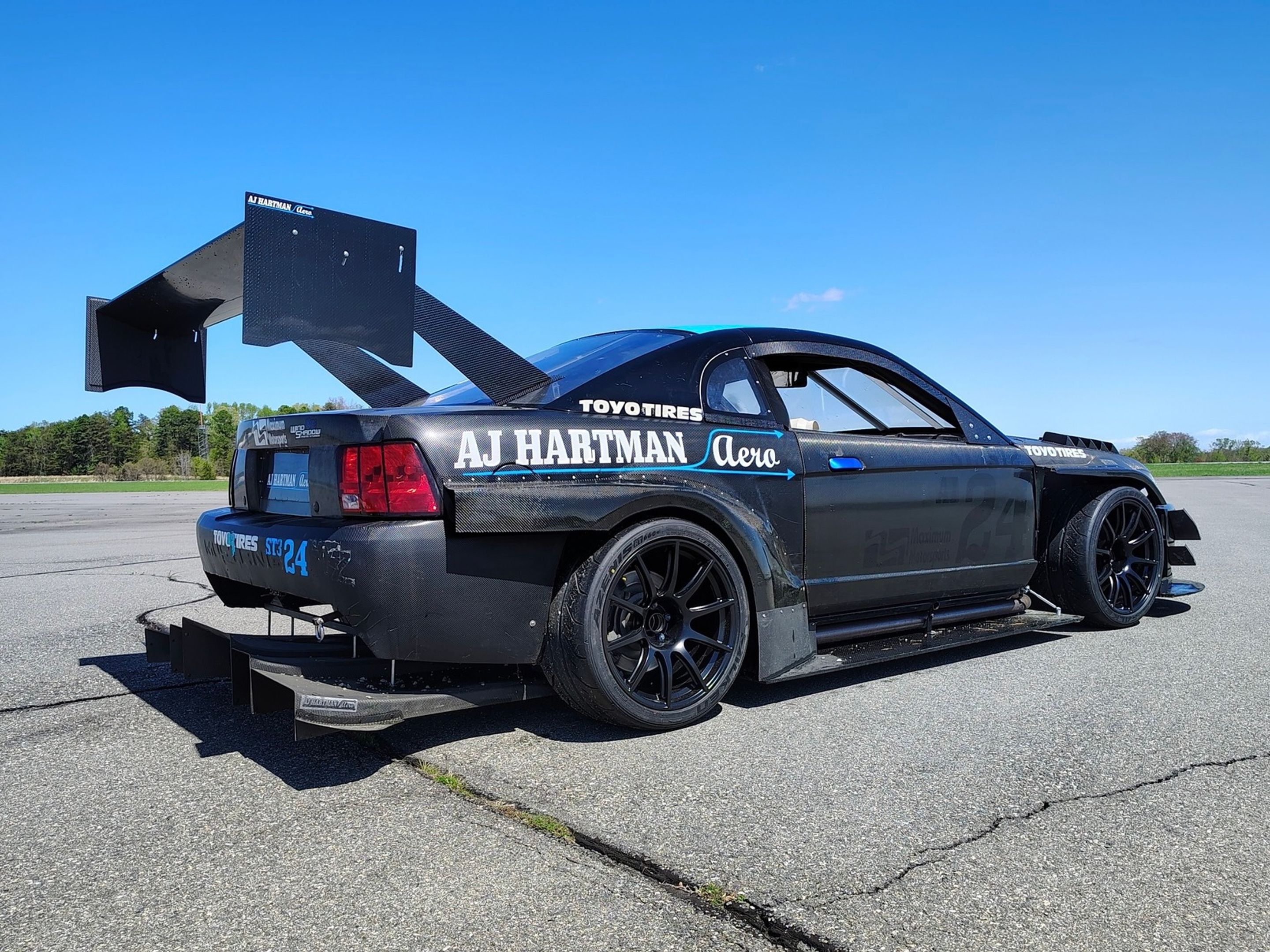 Black Ford SN95 Mustang V6 with 19" SM-10 Apex wheels in Satin Black