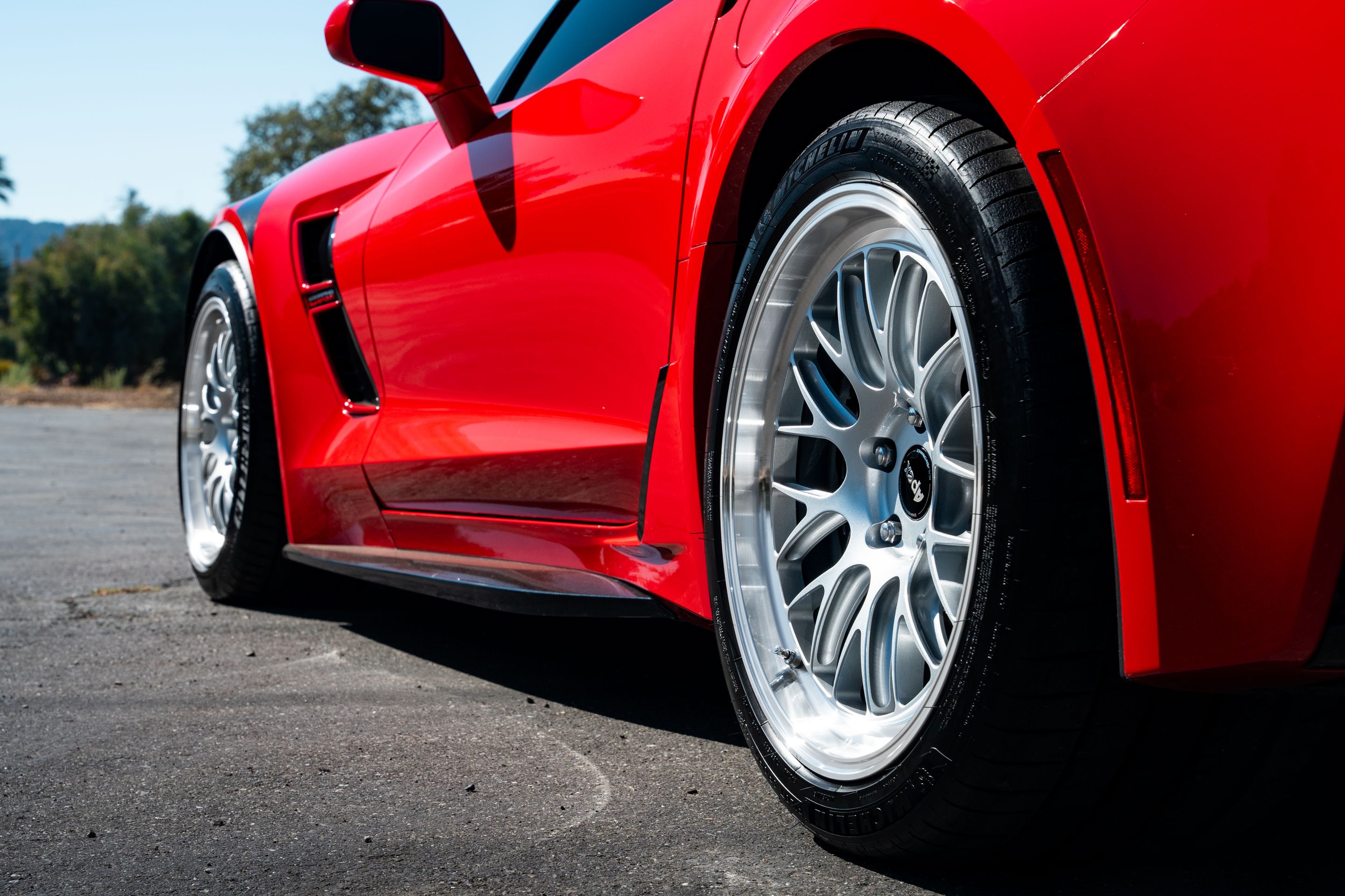 Red Chevrolet C7 Corvette Grand Sport with 18"/19" ML-10RT Apex wheels in Machined Lip Race Silver