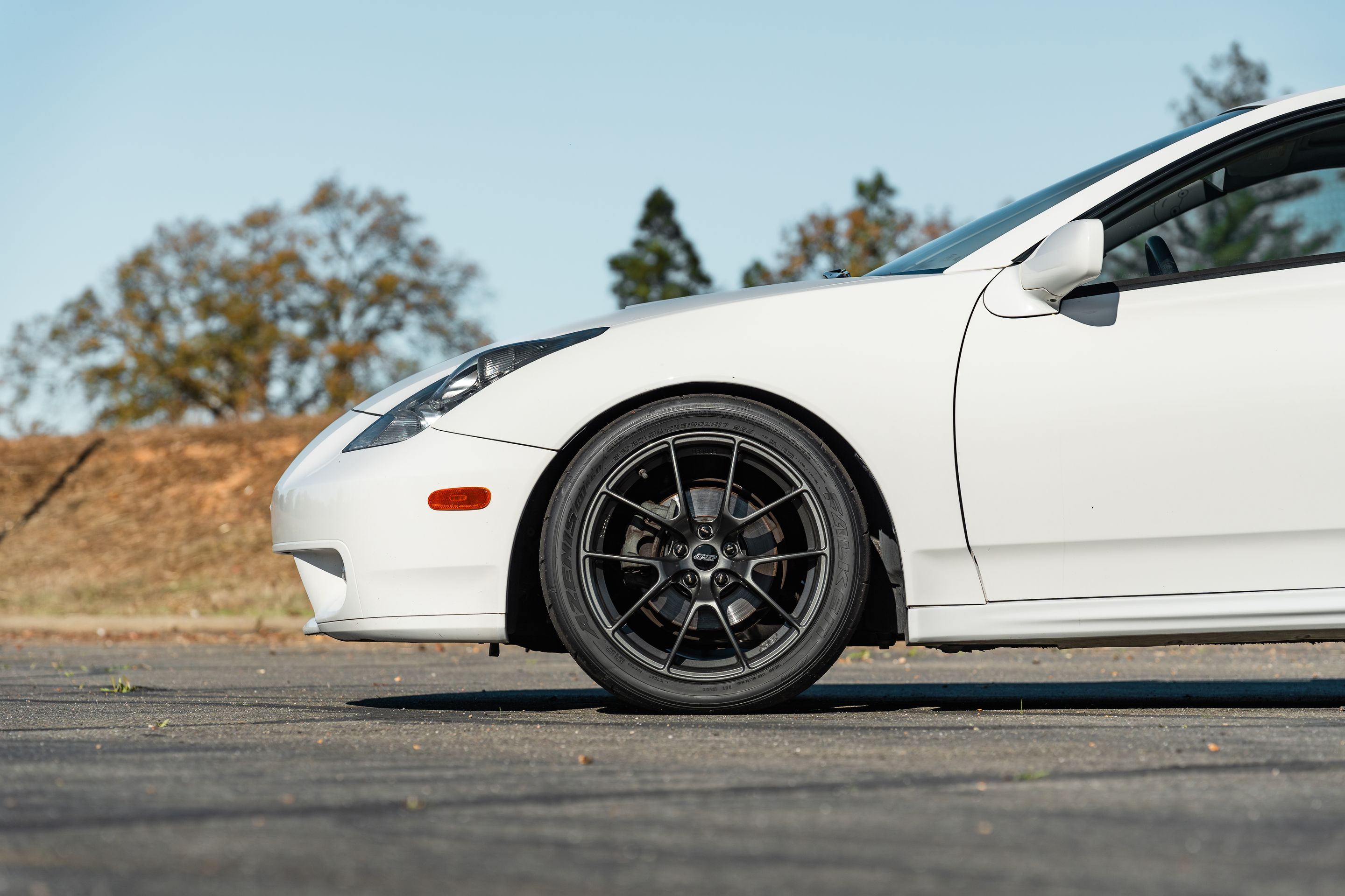 White Toyota 7th Gen Celica with 17" VS-5RS Apex wheels in Anthracite
