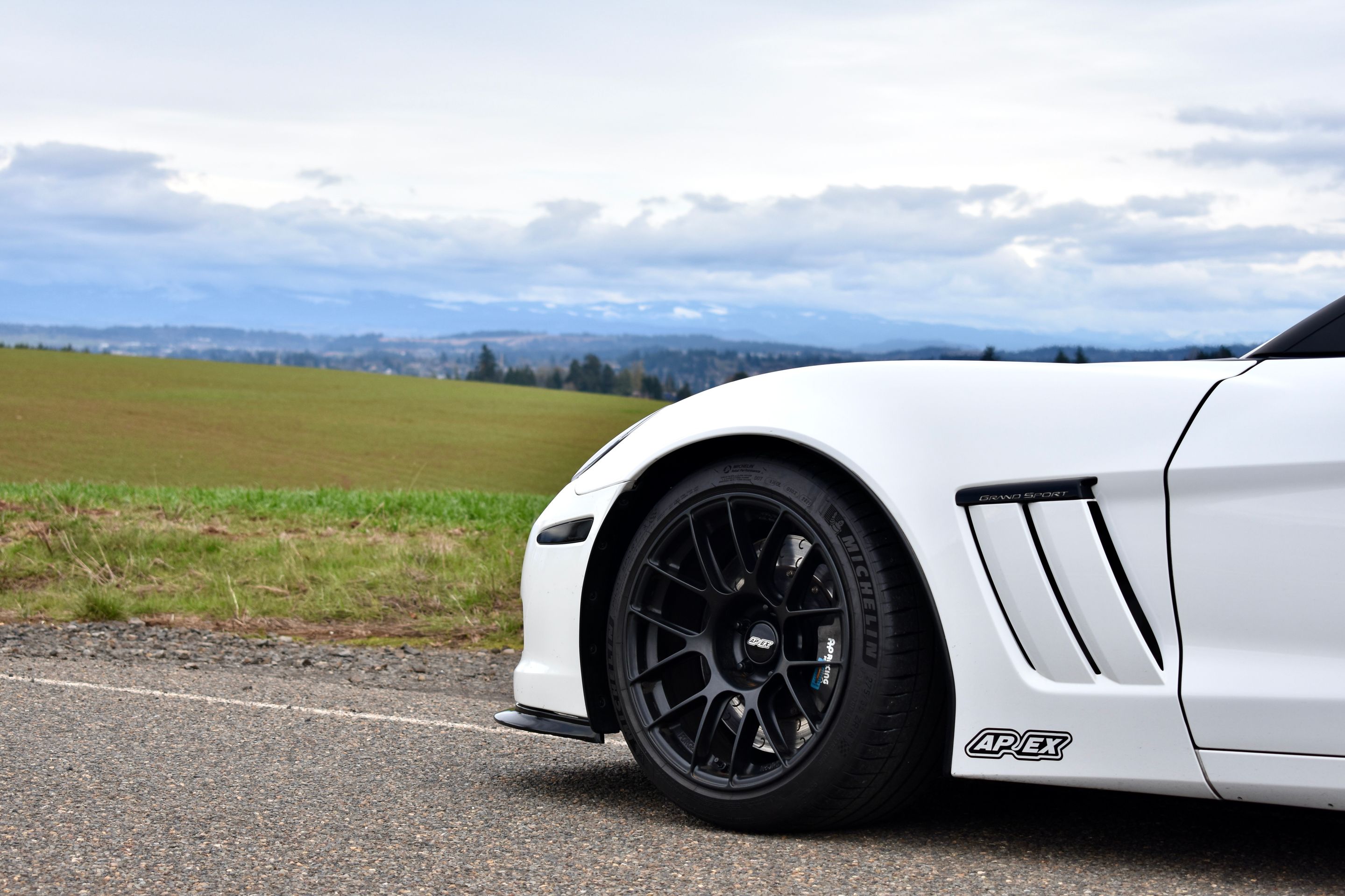 White Chevrolet C6 Corvette Grand Sport with 18"/19" EC-7RS Apex wheels in Satin Black