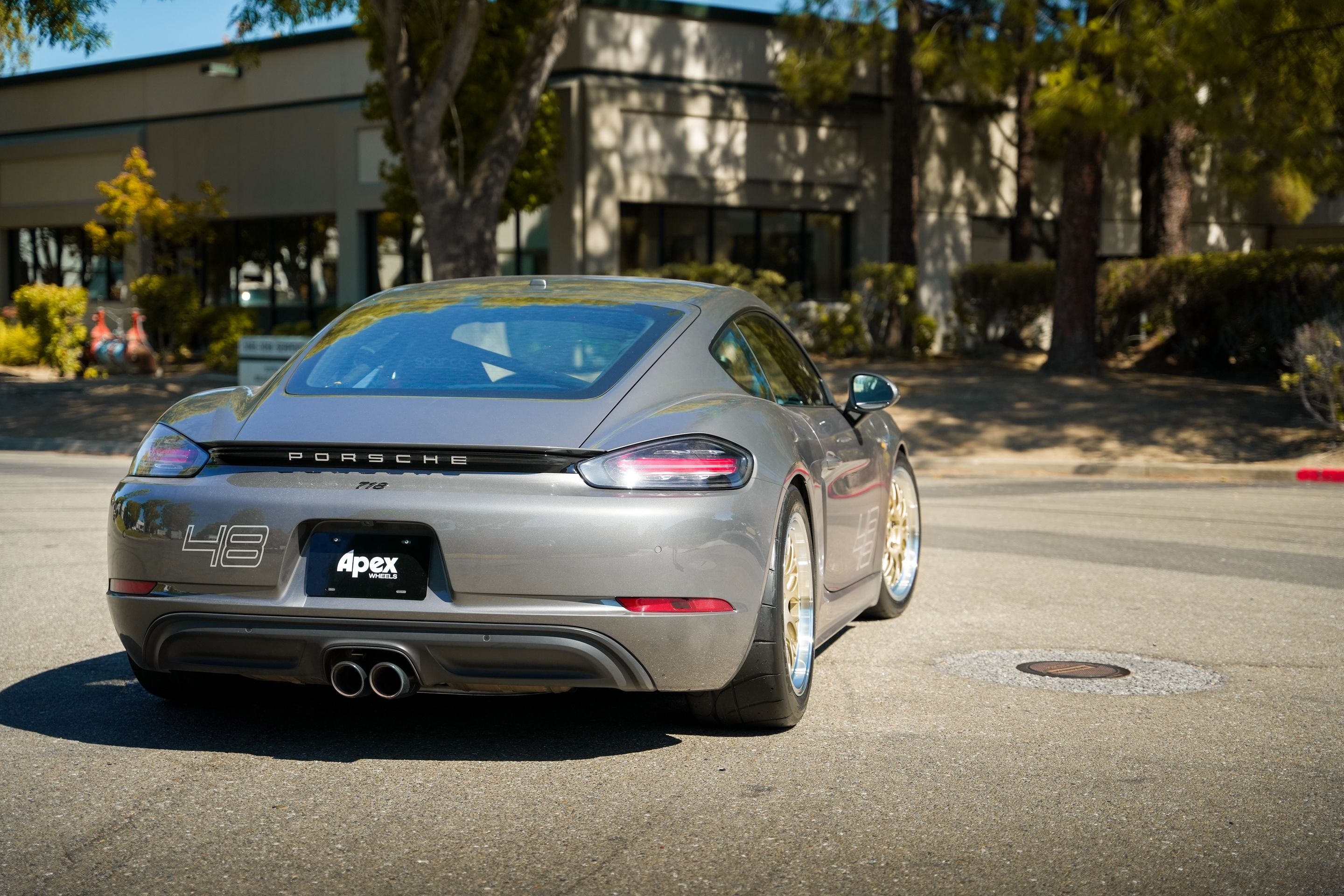 Grey Porsche 718 Cayman S with 18" ML-10RT Apex wheels in Machined Lip Gloss Motorsport Gold