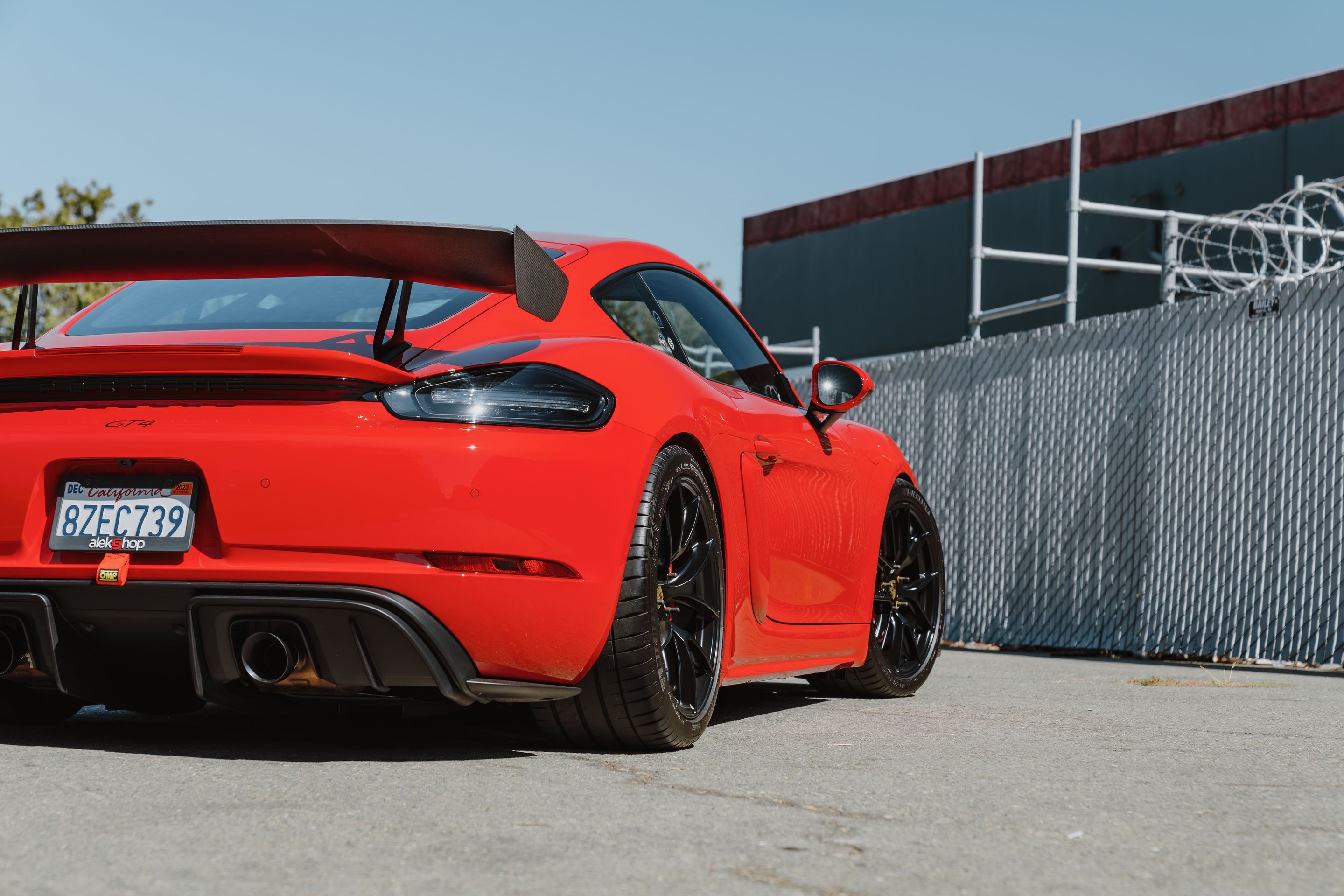Red Porsche 718 Cayman GT4 with 19" VS-5RS Apex wheels in Satin Black