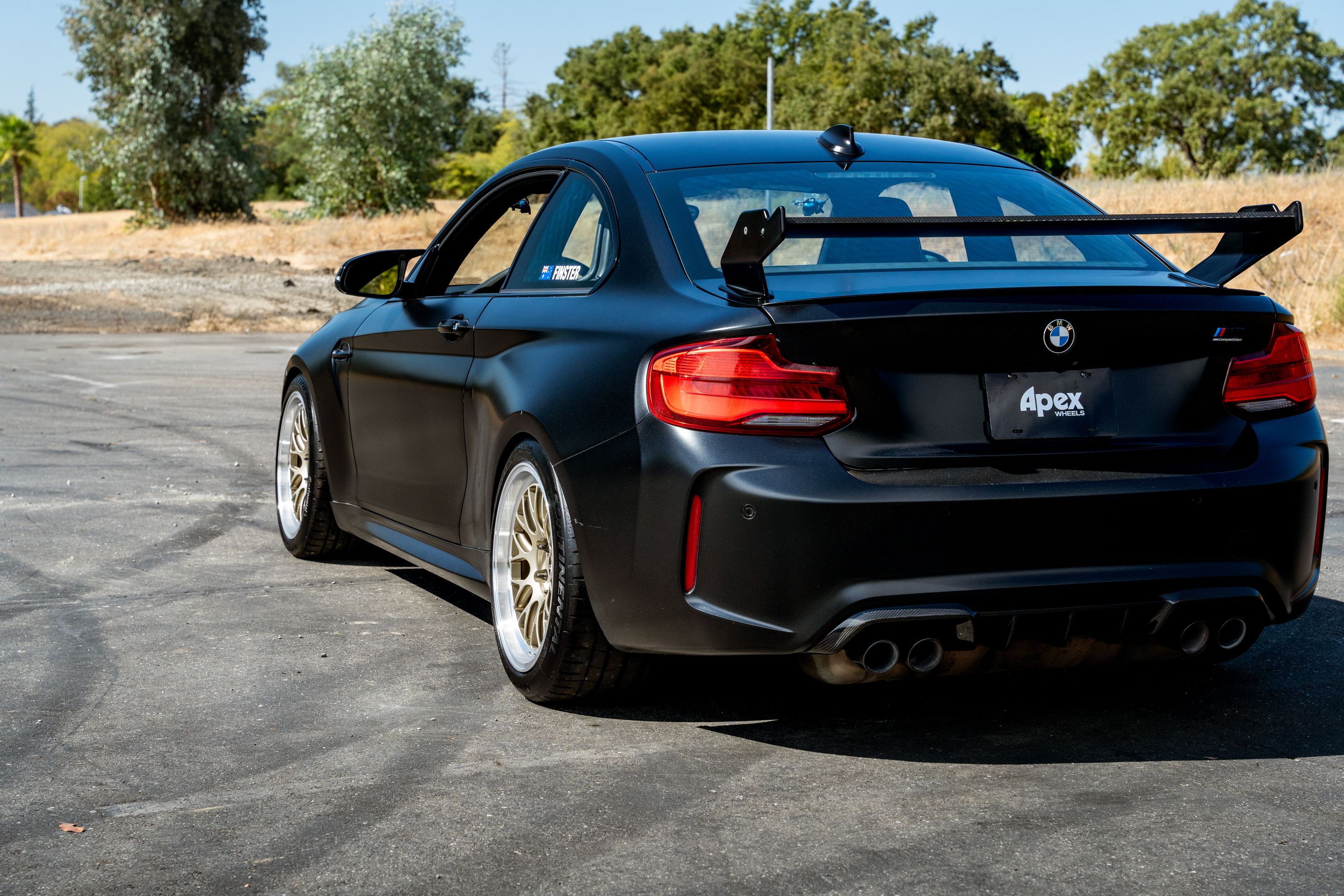 Black BMW F87 M2 with 18" ML-10RT Apex wheels in Machined Lip Gloss Motorsport Gold