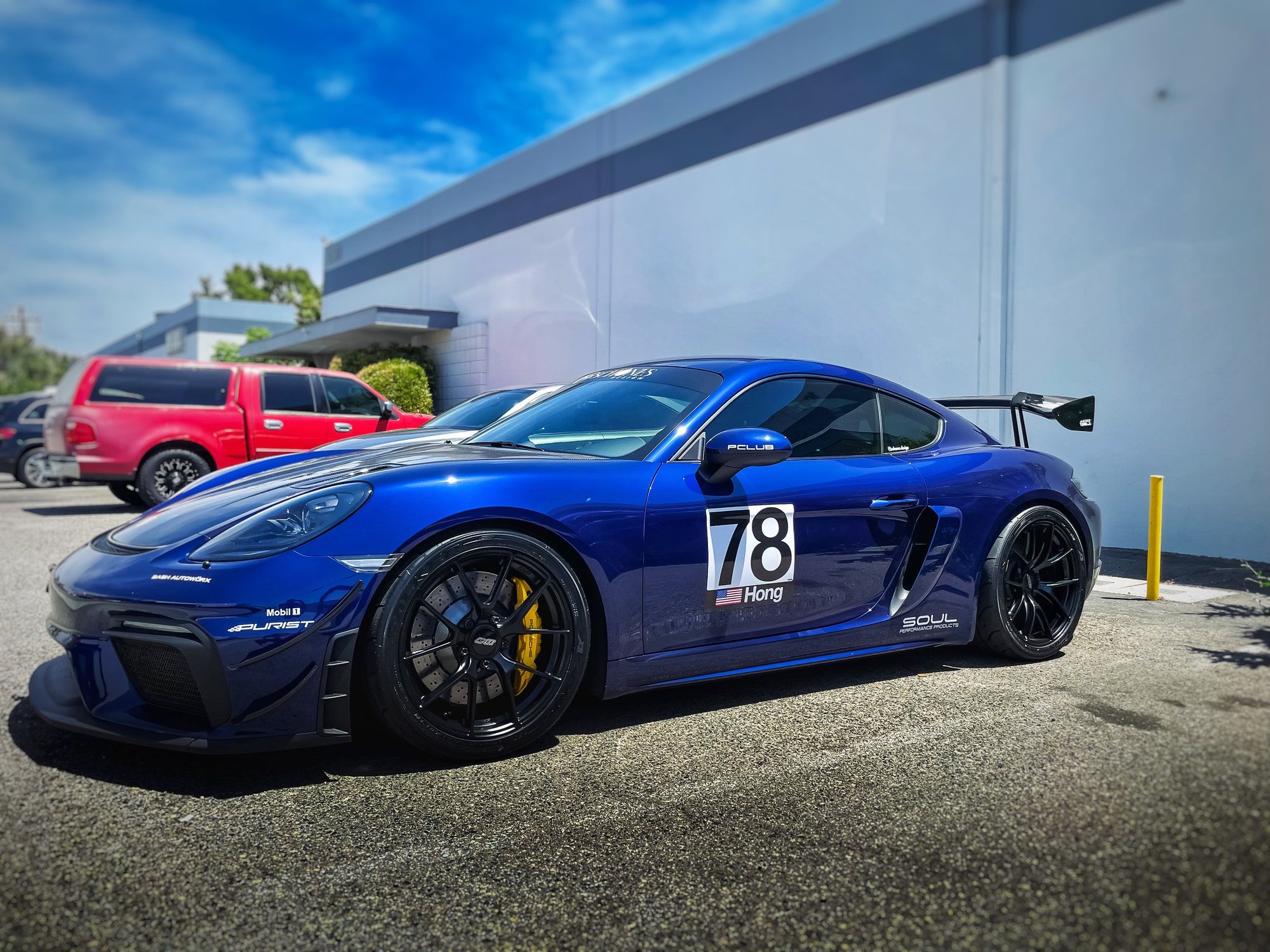 Blue Porsche 718 Cayman GT4 with 19" VS-5RS Apex wheels in Satin Black