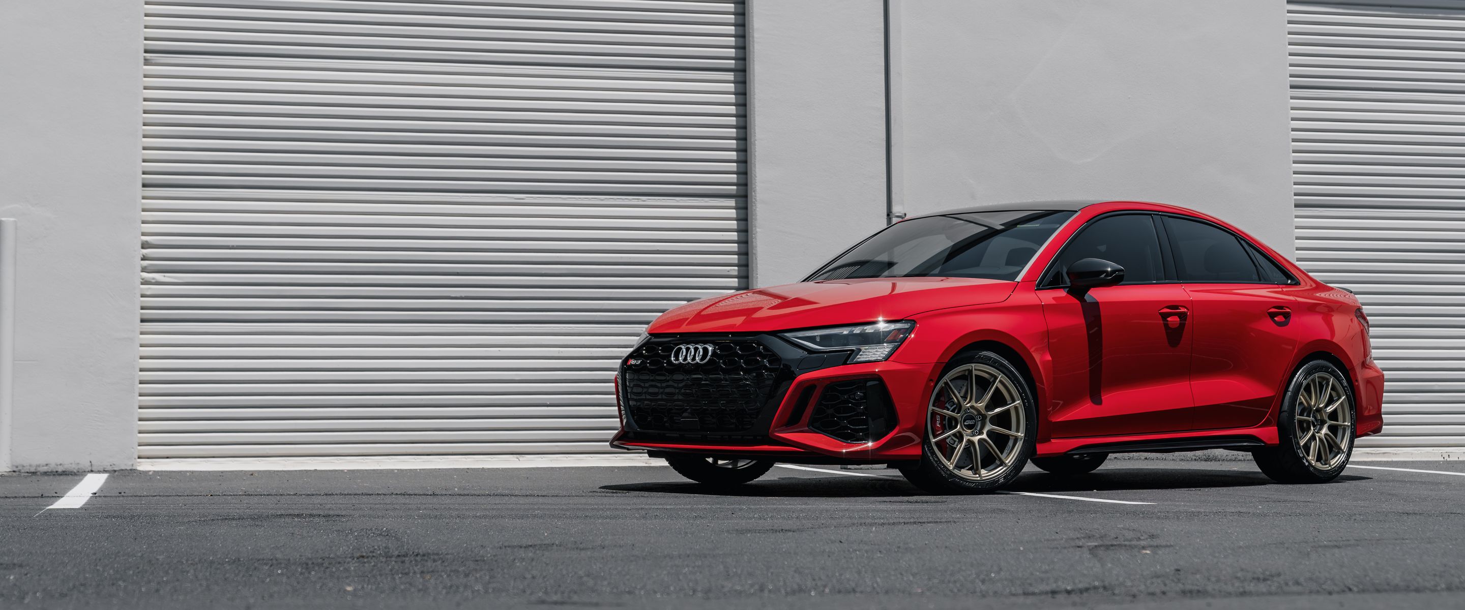 Red Audi 8Y RS 3 with 18" SM-10RS Apex wheels in Motorsport Gold