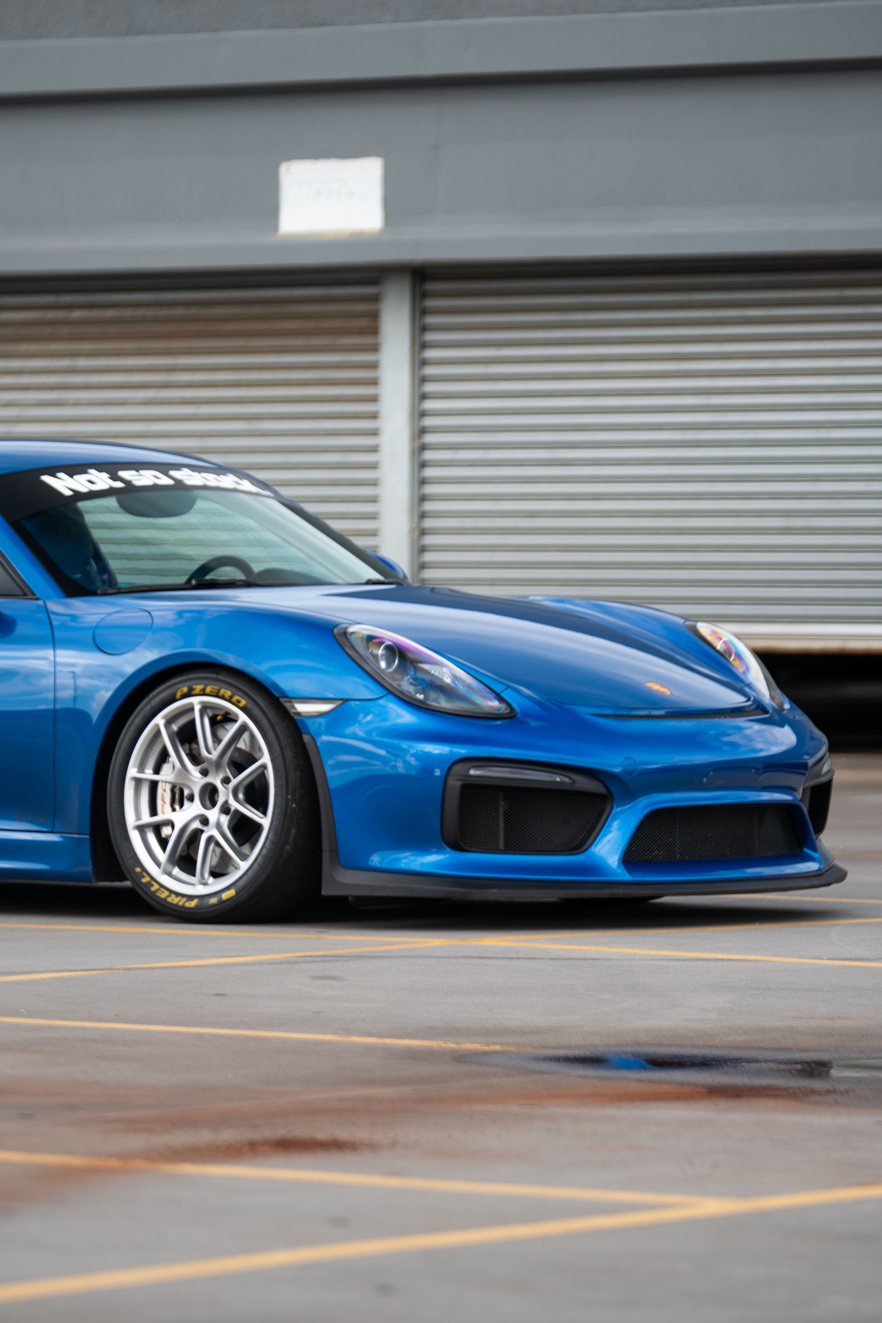 Blue Porsche 981 Cayman GT4 with 18" VS-5RE Apex wheels in Race Silver