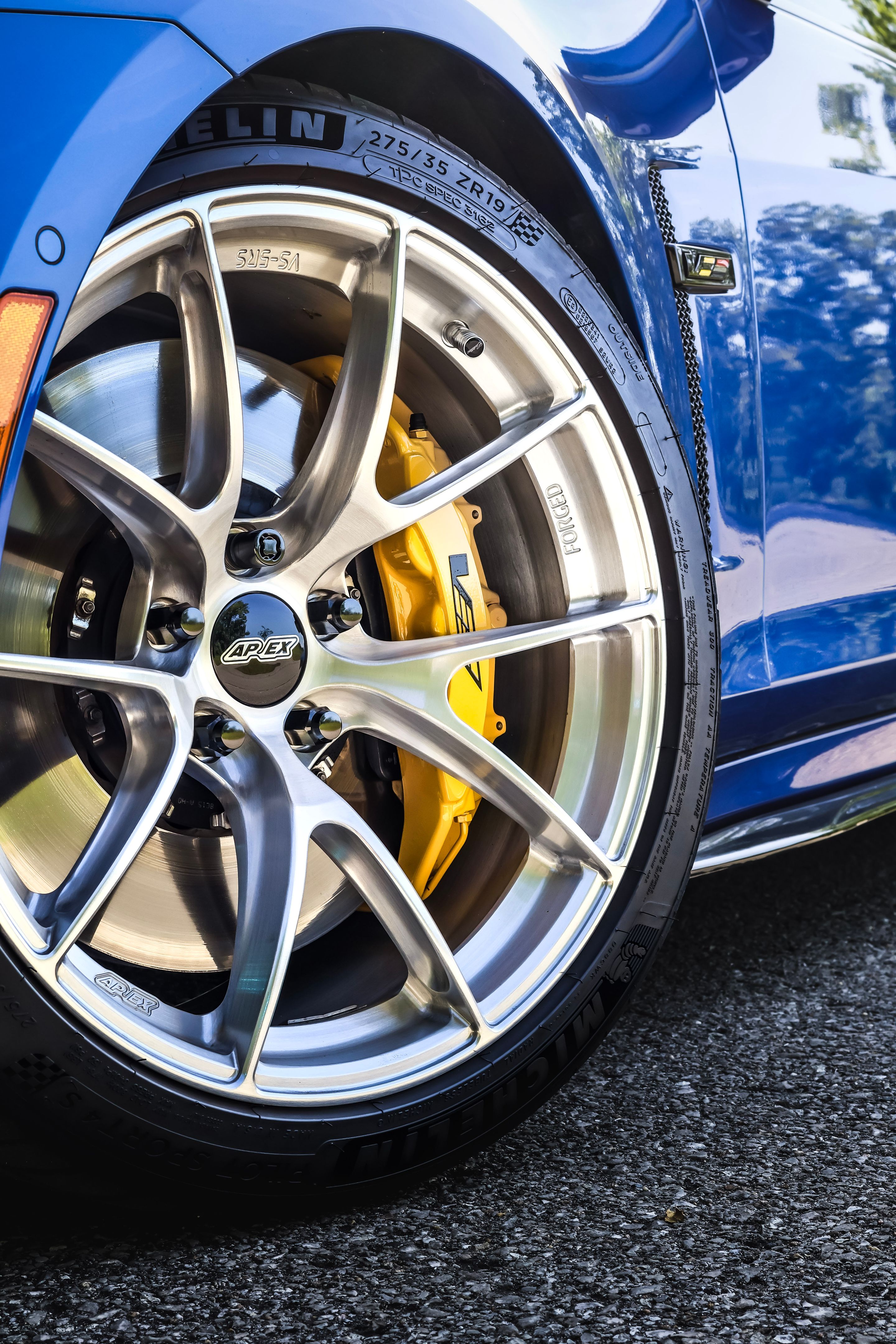 Blue Cadillac Gen 3 CTS-V with 19" VS-5RS Apex wheels in Brushed Clear