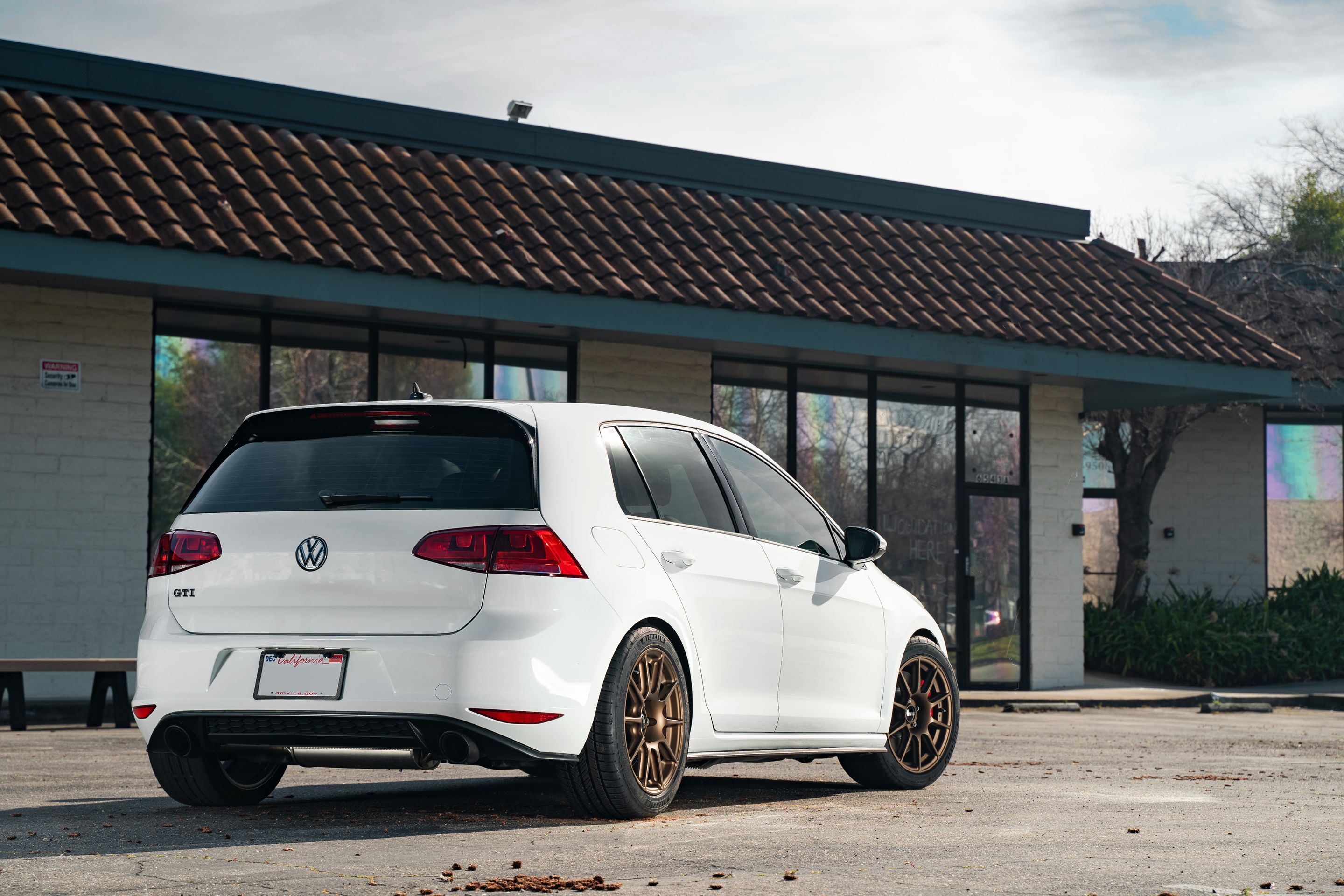 White VW MK7 GTI with 17" SM-10 Apex wheels in Satin Bronze
