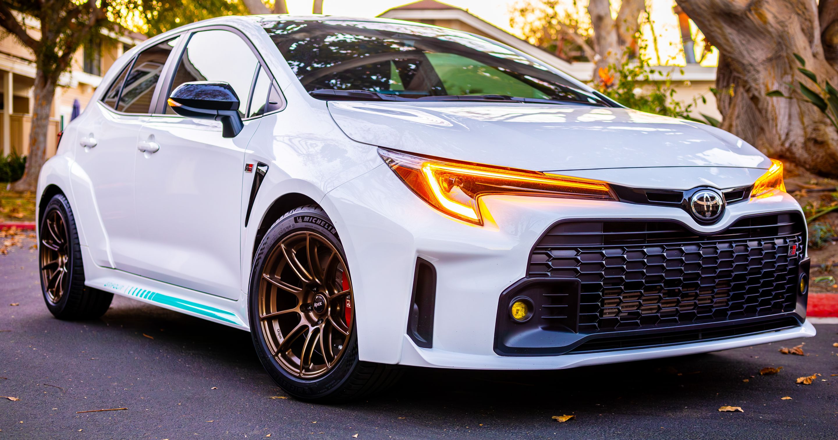 White Toyota GR Corolla with 17" SM-10RS Apex wheels in Satin Bronze