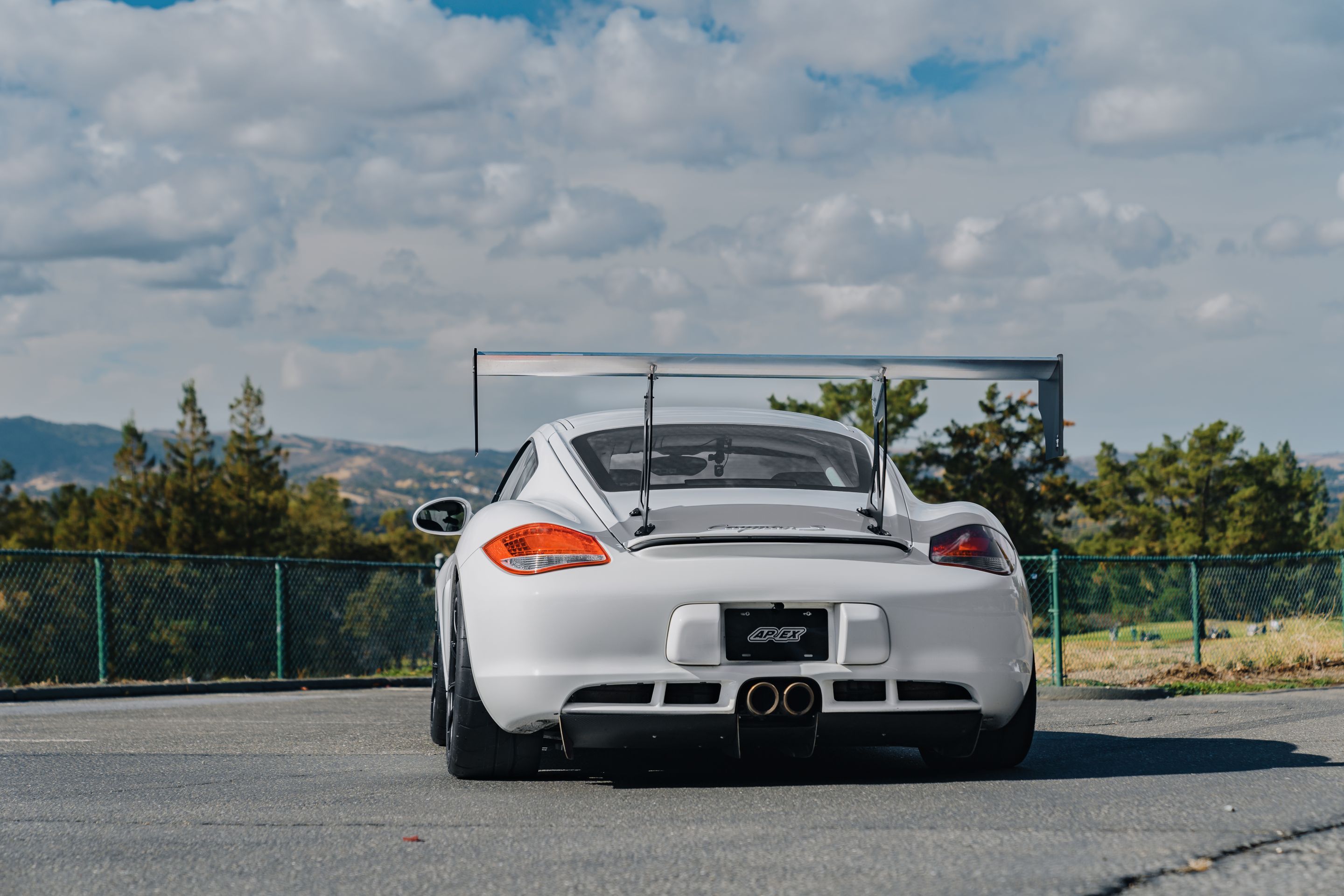White Porsche 987 Cayman S with 18" SM-10RS Apex wheels in Satin Black