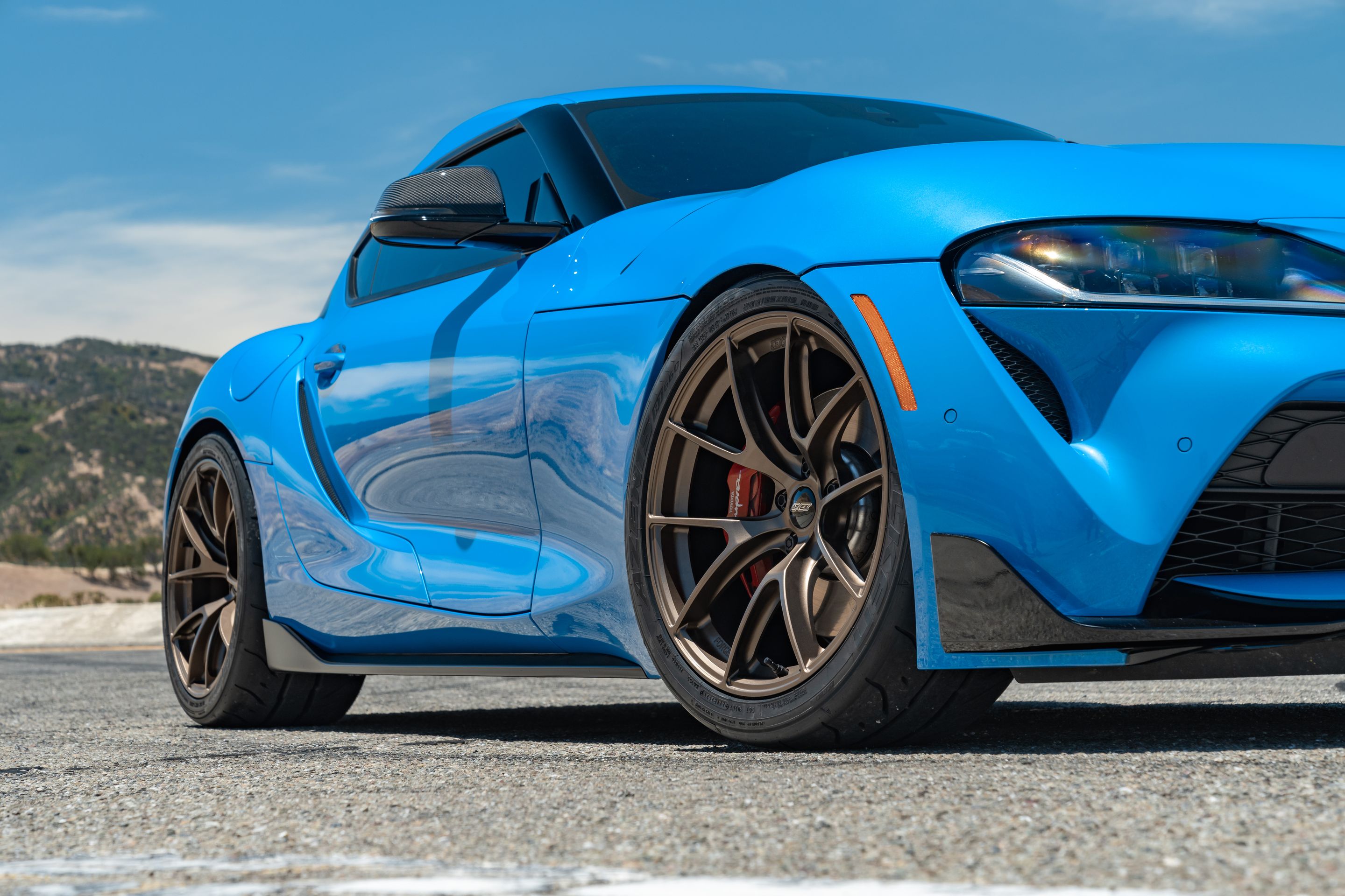 Blue Toyota GR Supra with 19" VS-5RS Apex wheels in Satin Bronze
