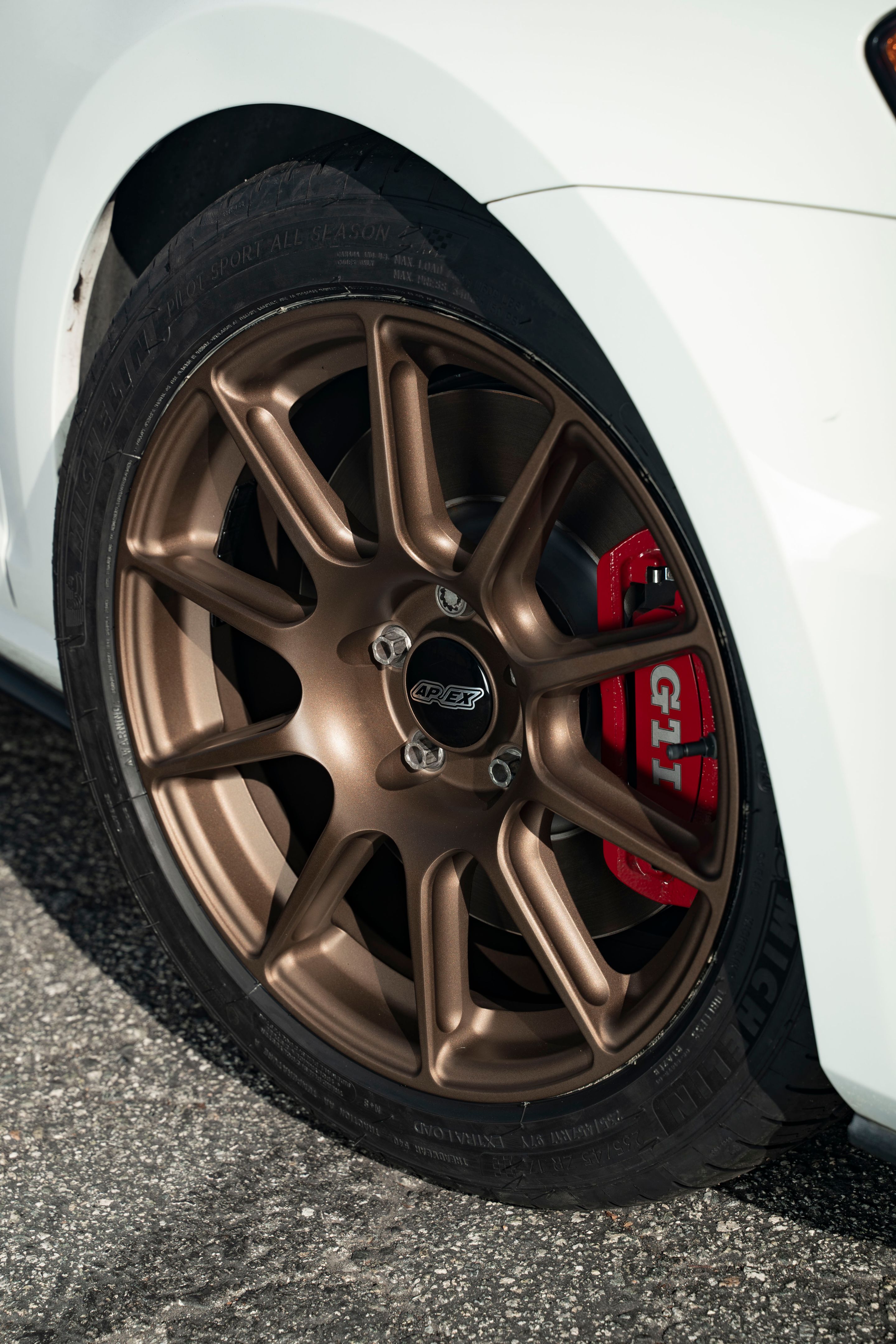 White VW MK7 GTI with 17" SM-10 Apex wheels in Satin Bronze