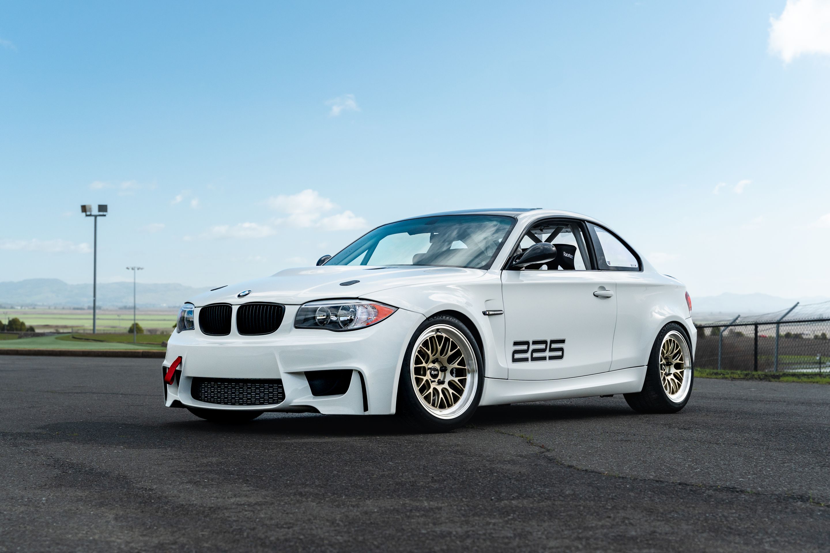 White BMW E82 1M with 18" ML-10RT Apex wheels in Machined Lip Gloss Motorsport Gold