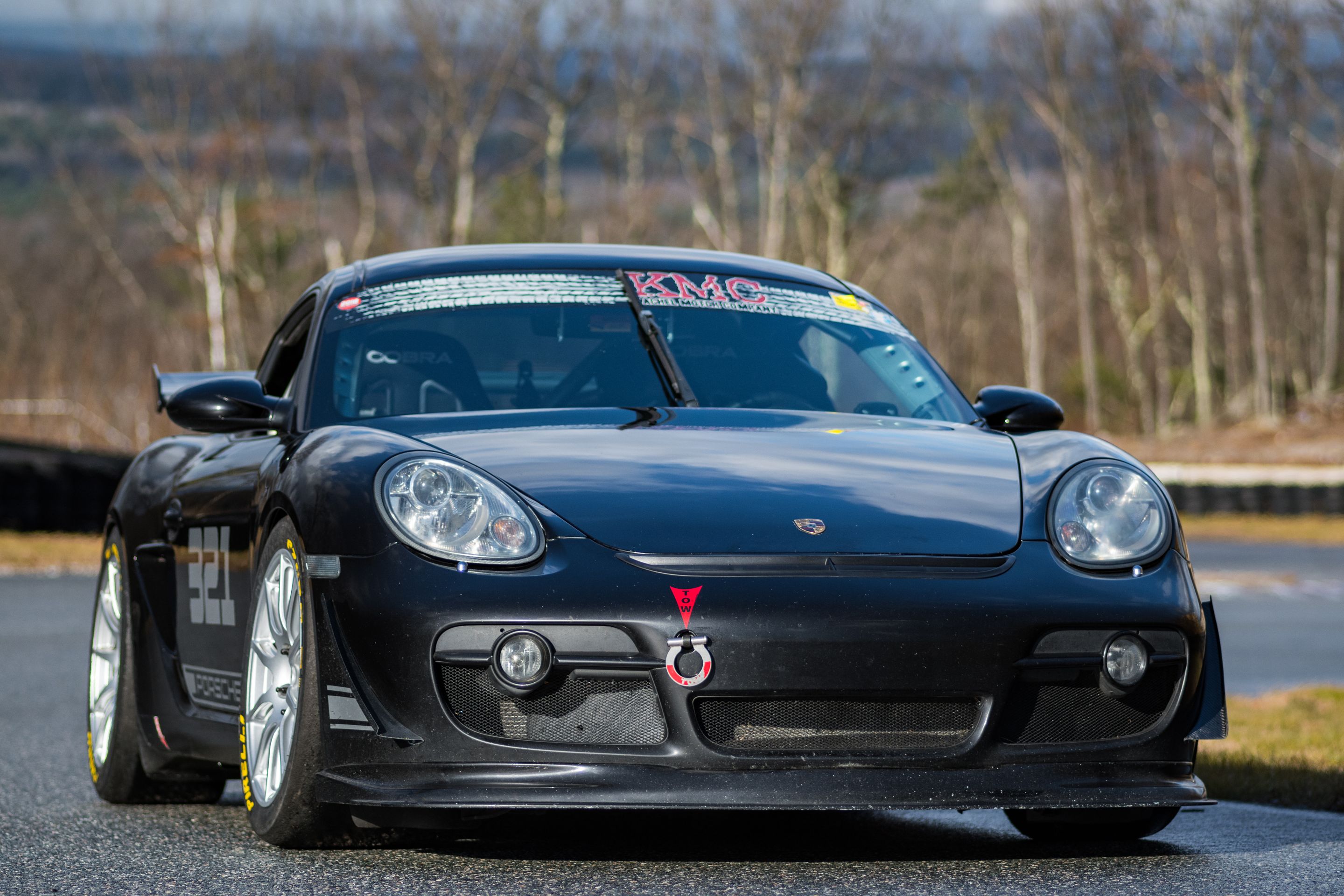 Black Porsche 987 Cayman S with 18" SM-10 Apex wheels in Race Silver