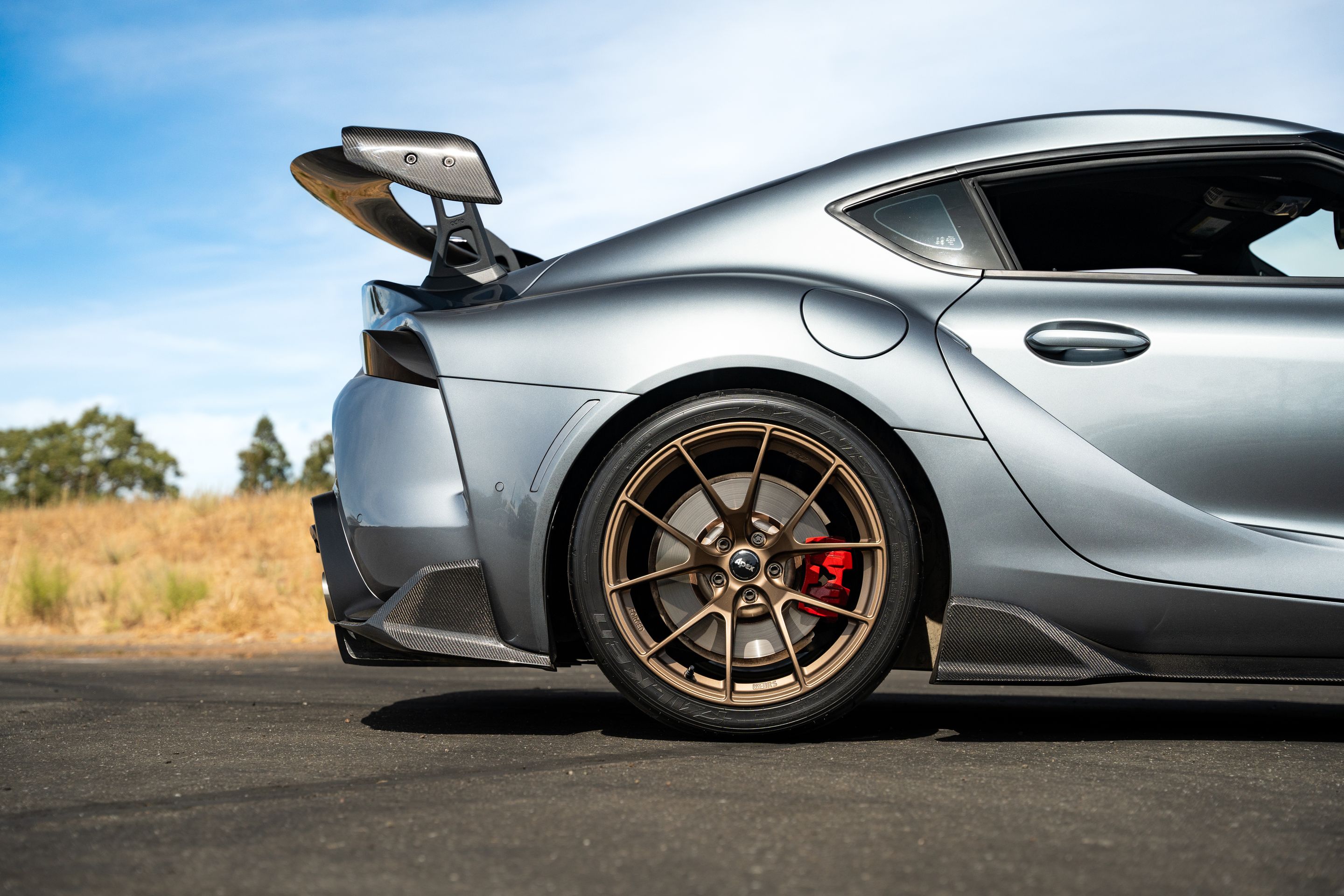 Grey Toyota GR Supra with 19" VS-5RS Apex wheels in Satin Bronze