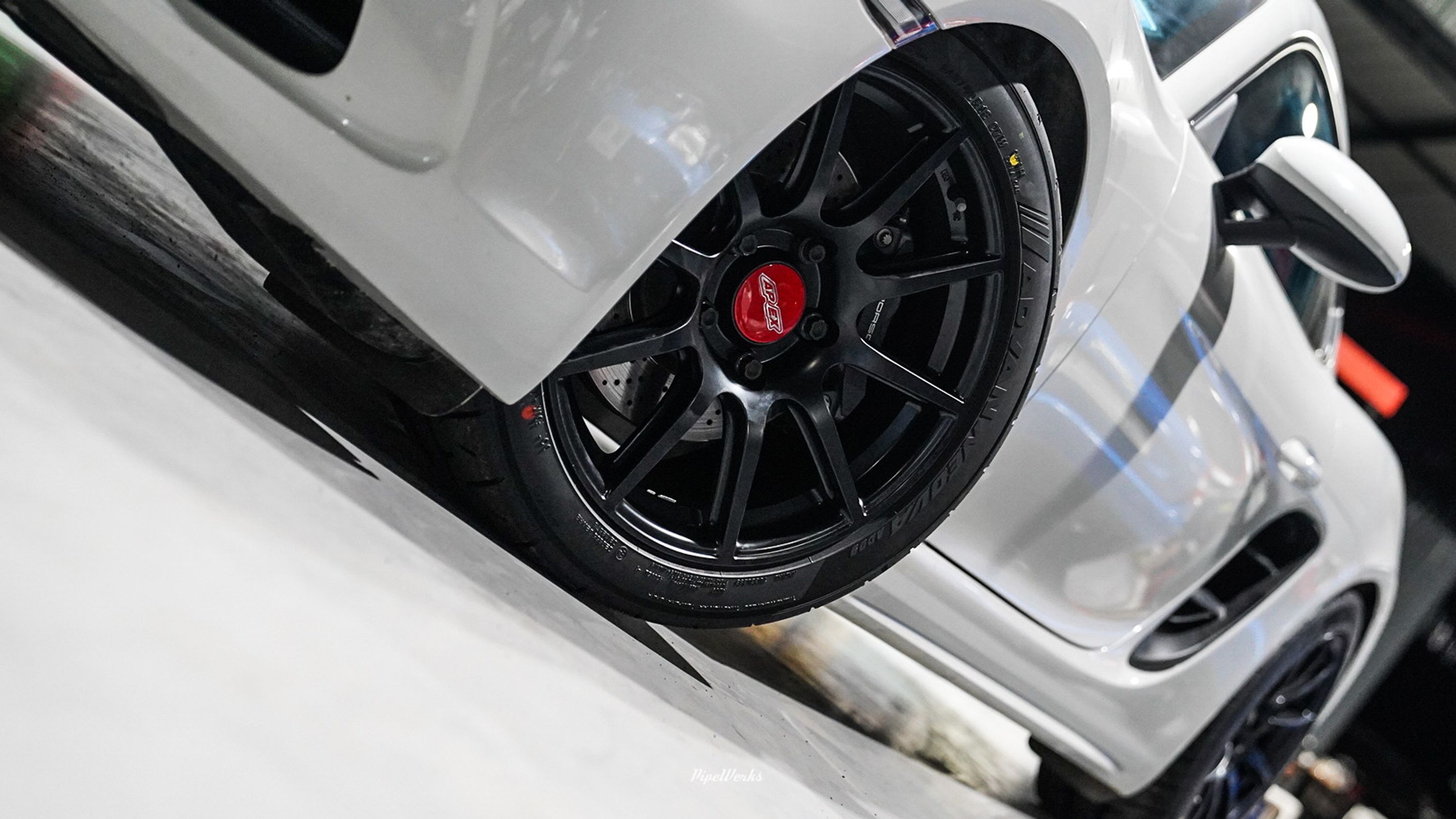 White Porsche 718 Cayman Base with 18" SM-10 Apex wheels in Satin Black