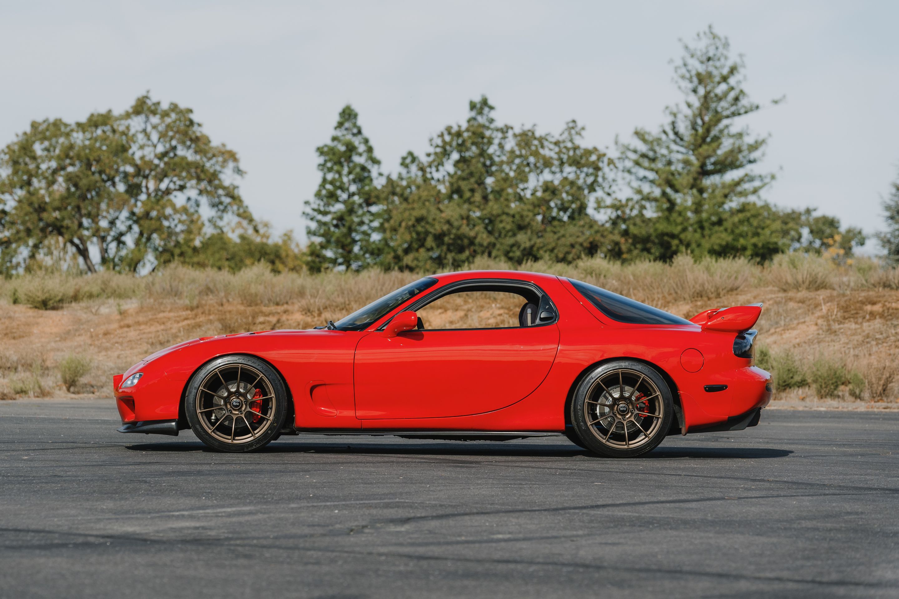 Red Mazda FD RX-7 with 18" SM-10RS Apex wheels in Satin Bronze