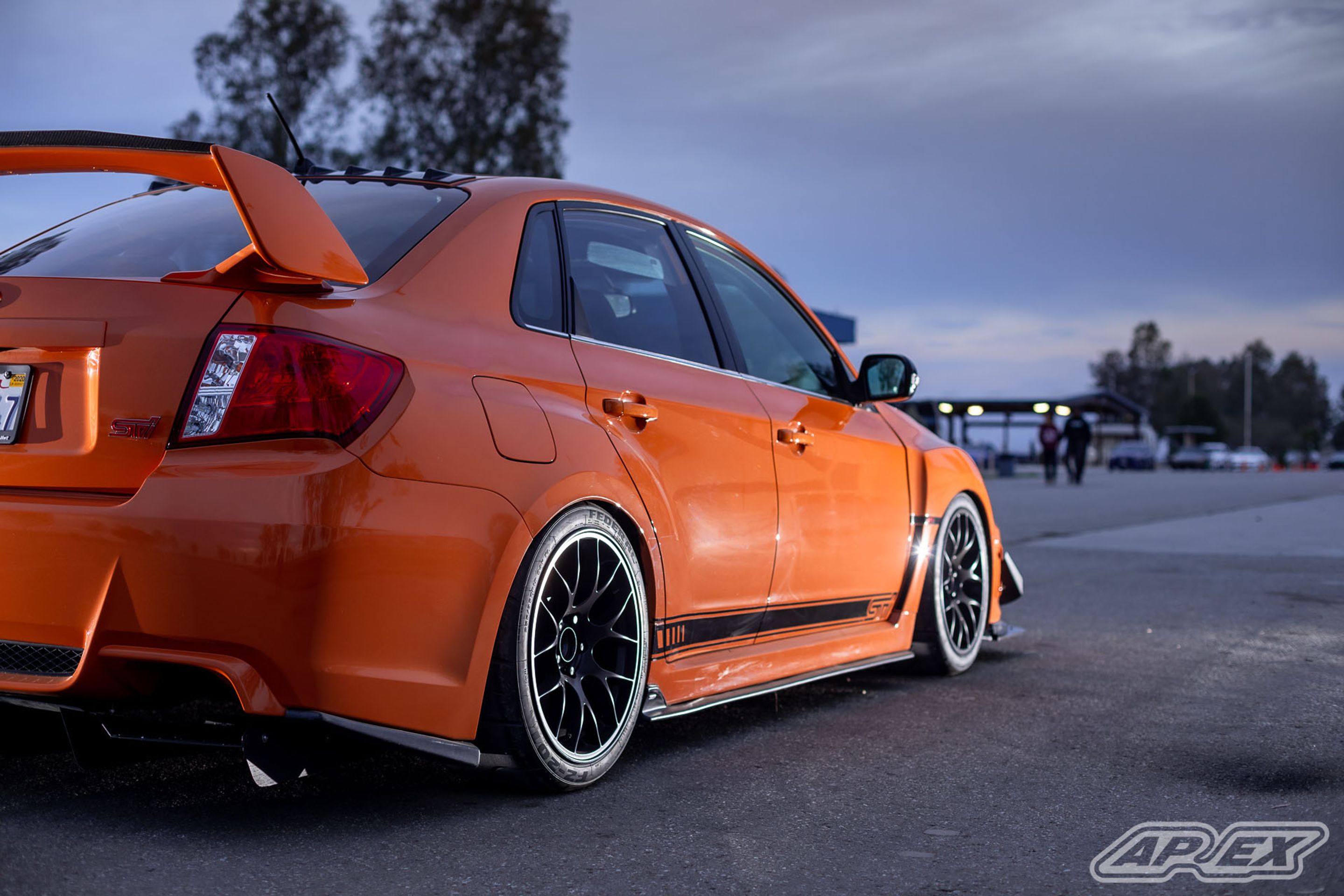 Orange Subaru GR WRX STI with 18" EC-7 Apex wheels in Satin Black