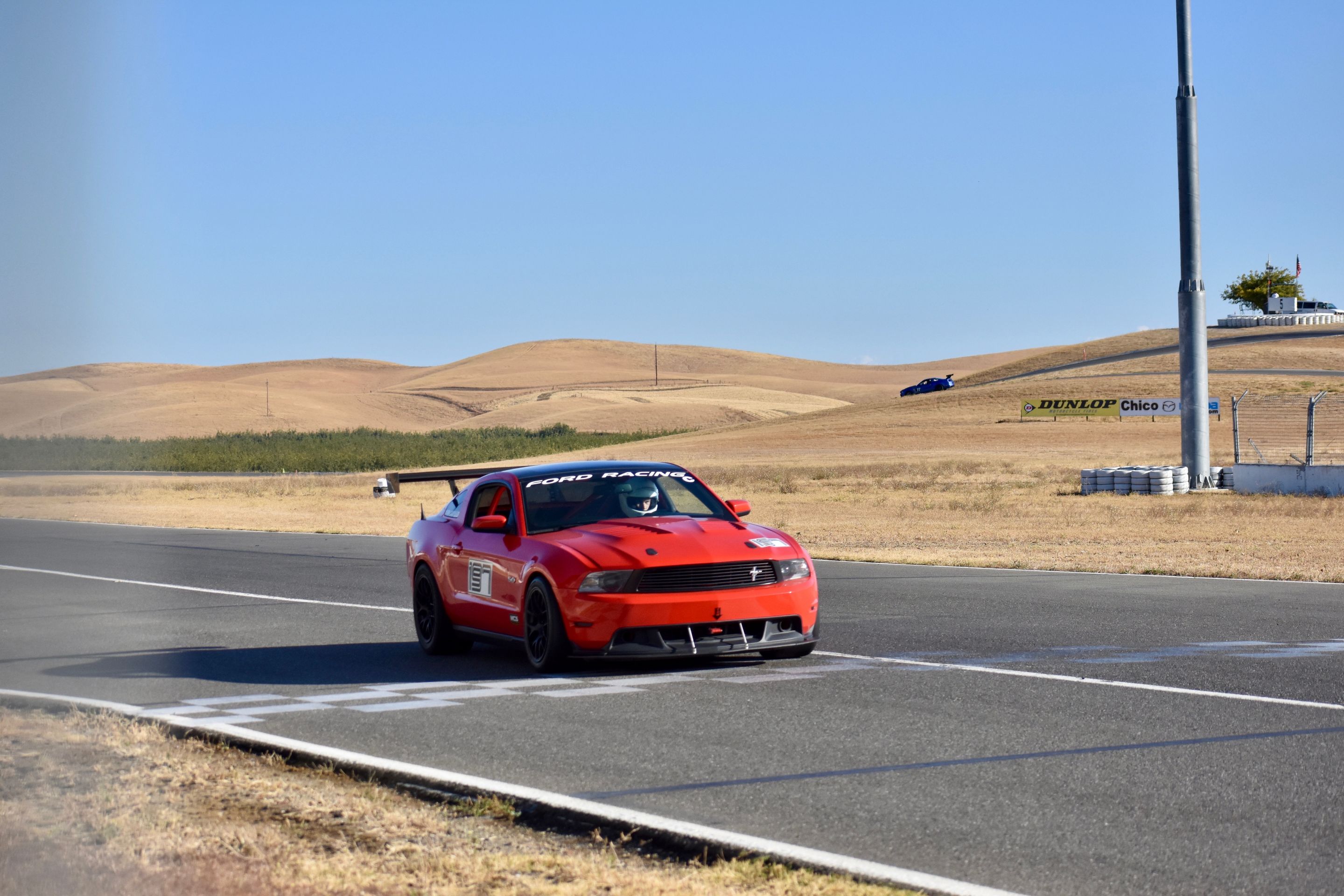Red Ford S197 Mustang GT with 18" EC-7 Apex wheels in Satin Black