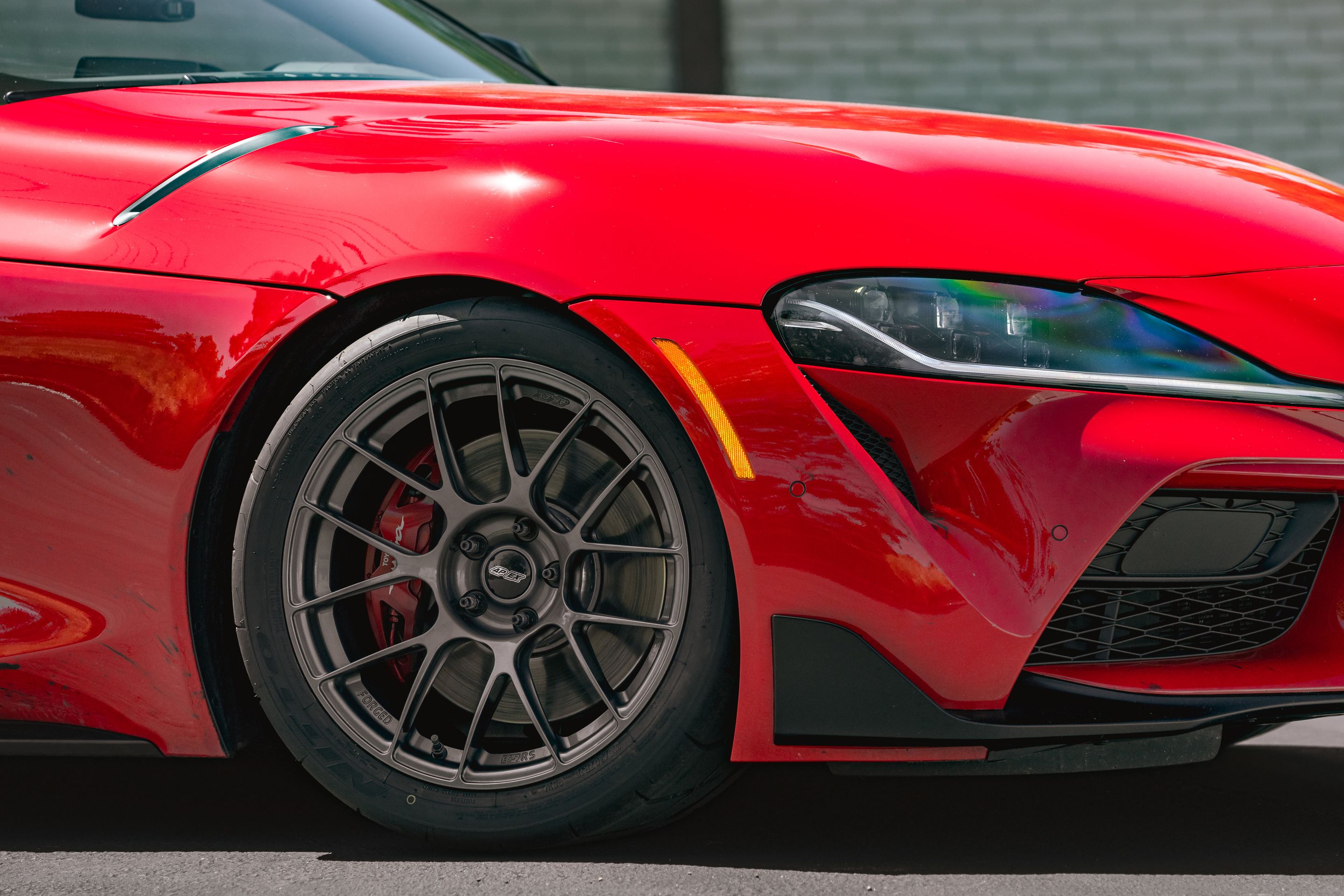 Red Toyota GR Supra with 18" EC-7RS Apex wheels in Anthracite