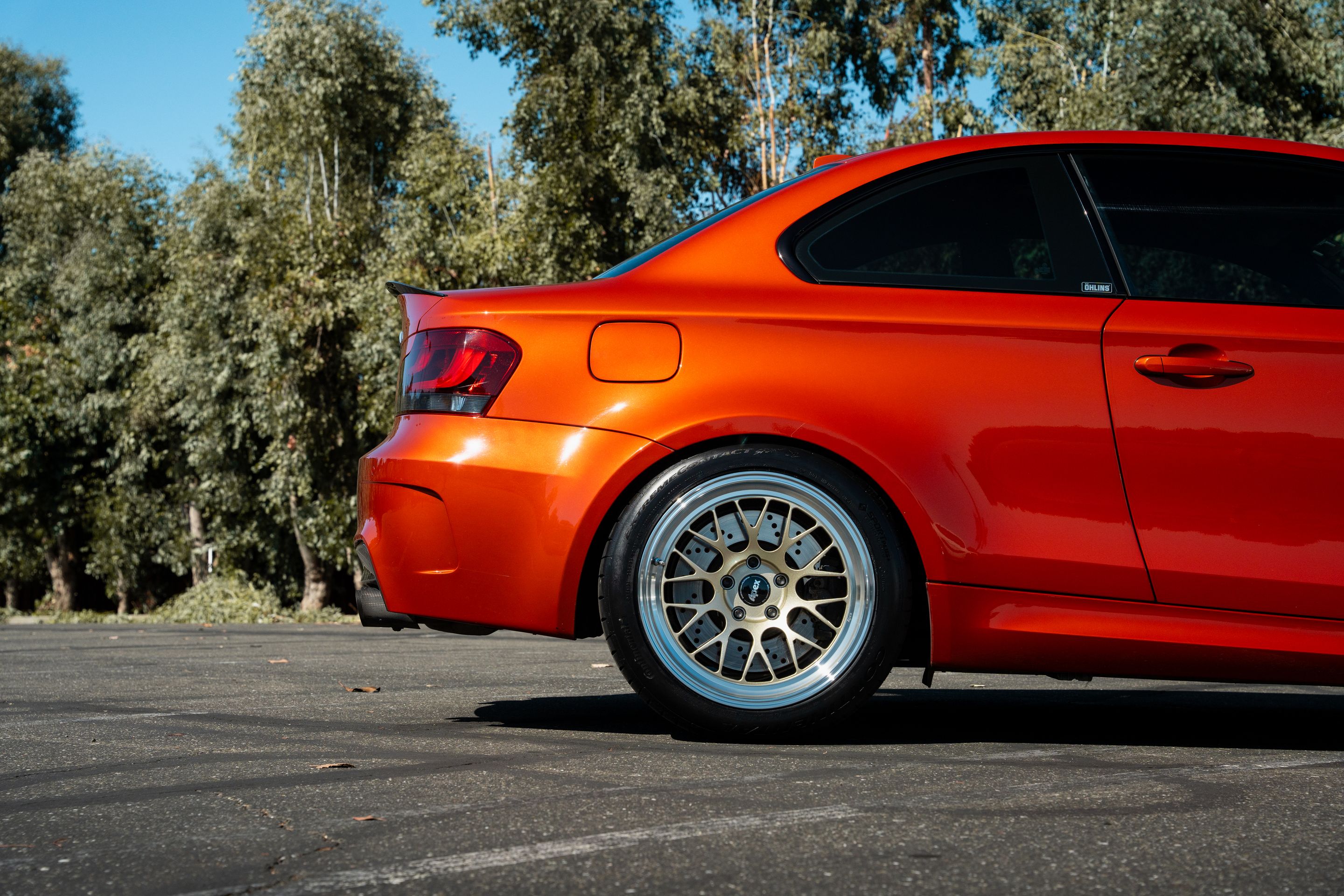 Orange BMW E82 1M with 18" ML-10RT Apex wheels in Machined Lip Gloss Motorsport Gold