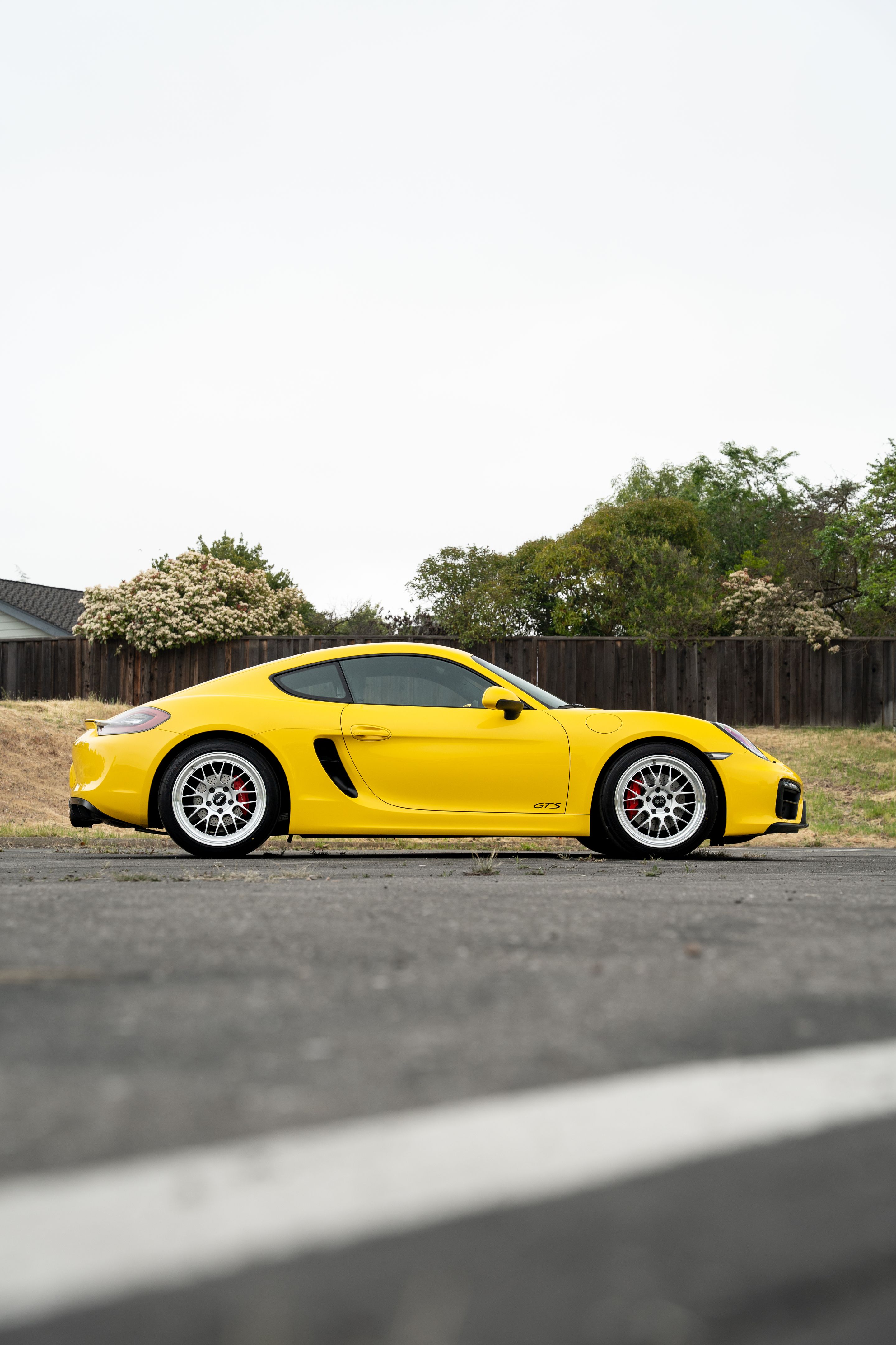 Yellow Porsche 981 Cayman GTS with 19" ML-10RT Apex wheels in Machined Lip Race Silver