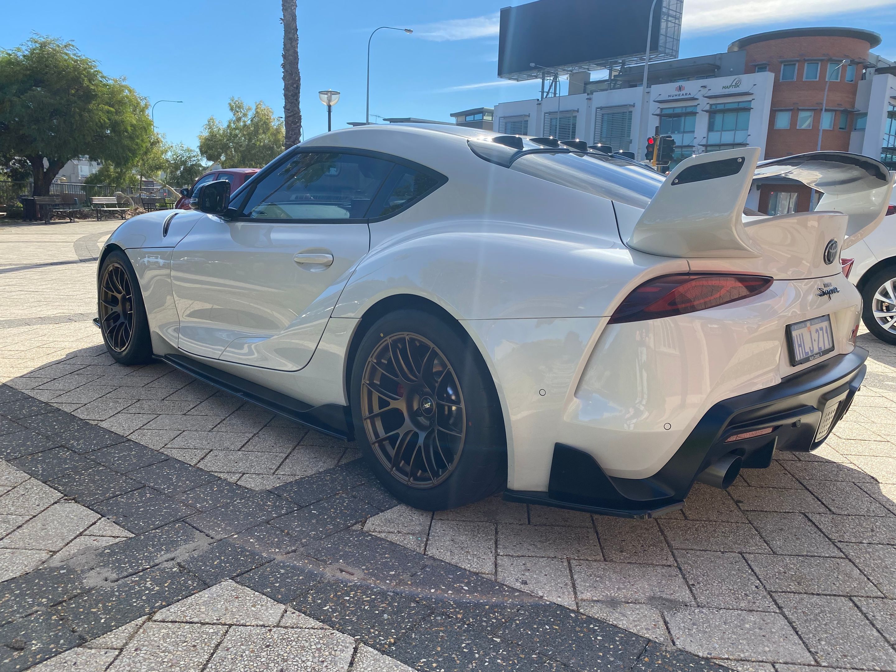 White Toyota GR Supra with 18" EC-7RS Apex wheels in Satin Bronze